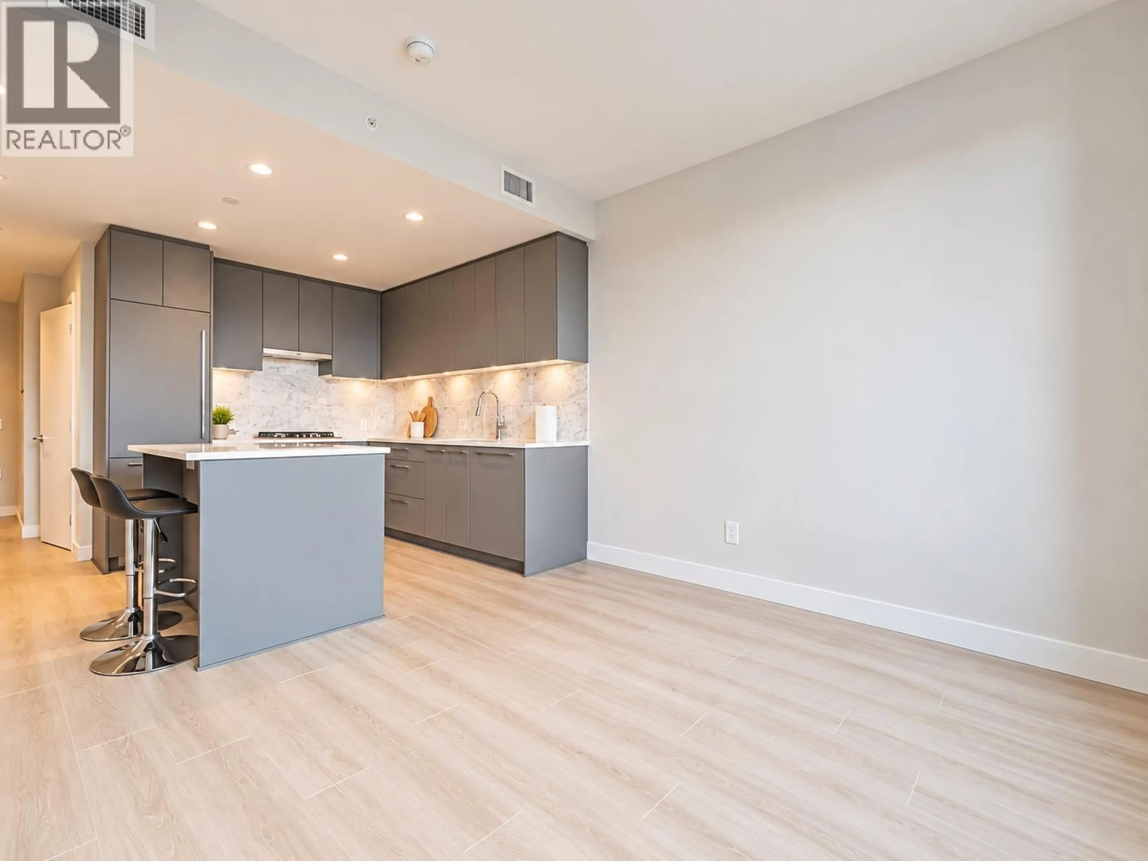 Open concept kitchen, wood/laminate floor for 509 - 5380 CROOKED BRANCH ROAD, Vancouver British Columbia V6T0E5