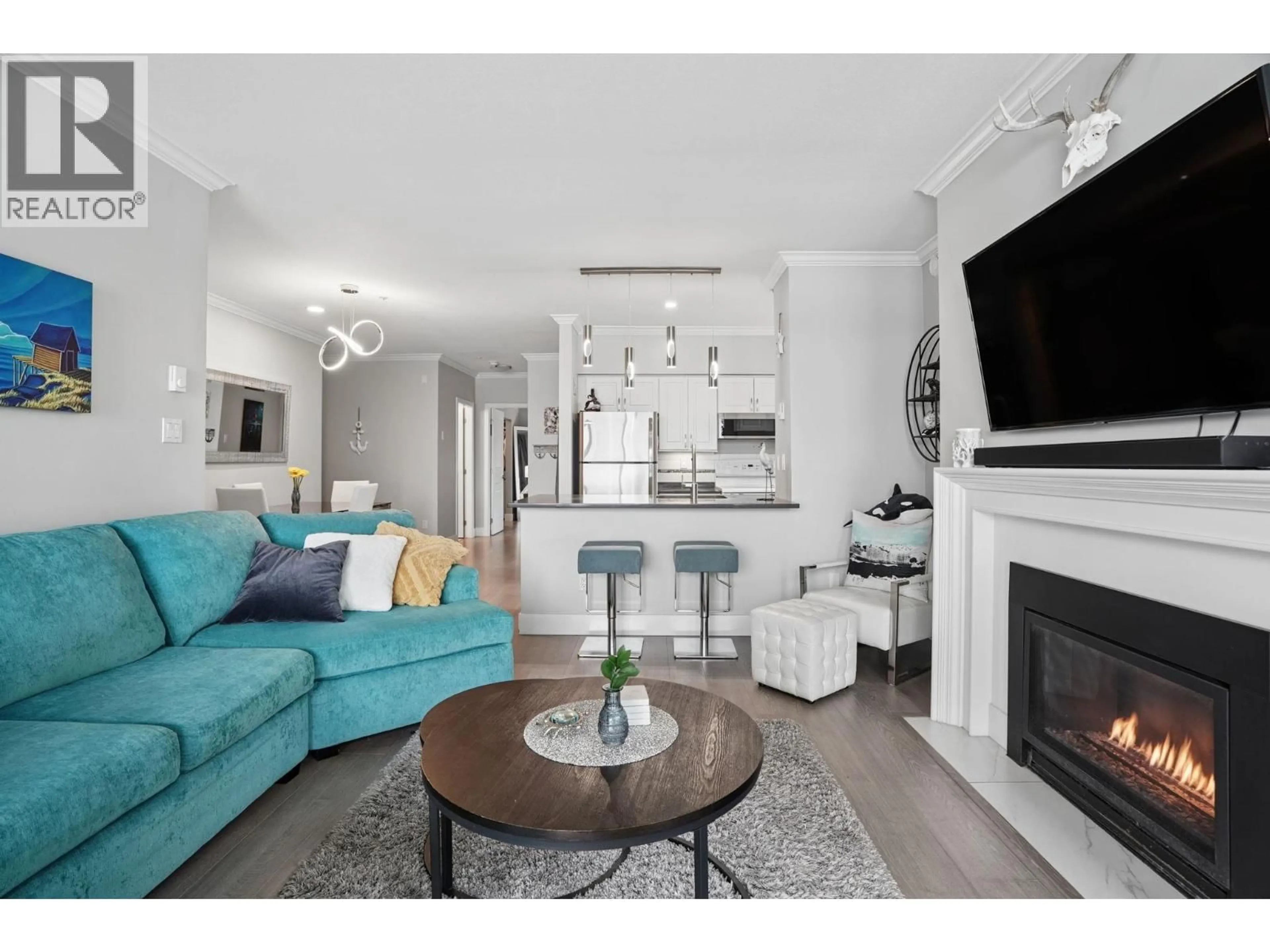 Living room with furniture, wood/laminate floor for 311 - 2020 KENT AVENUE SOUTH, Vancouver British Columbia V5P4X1