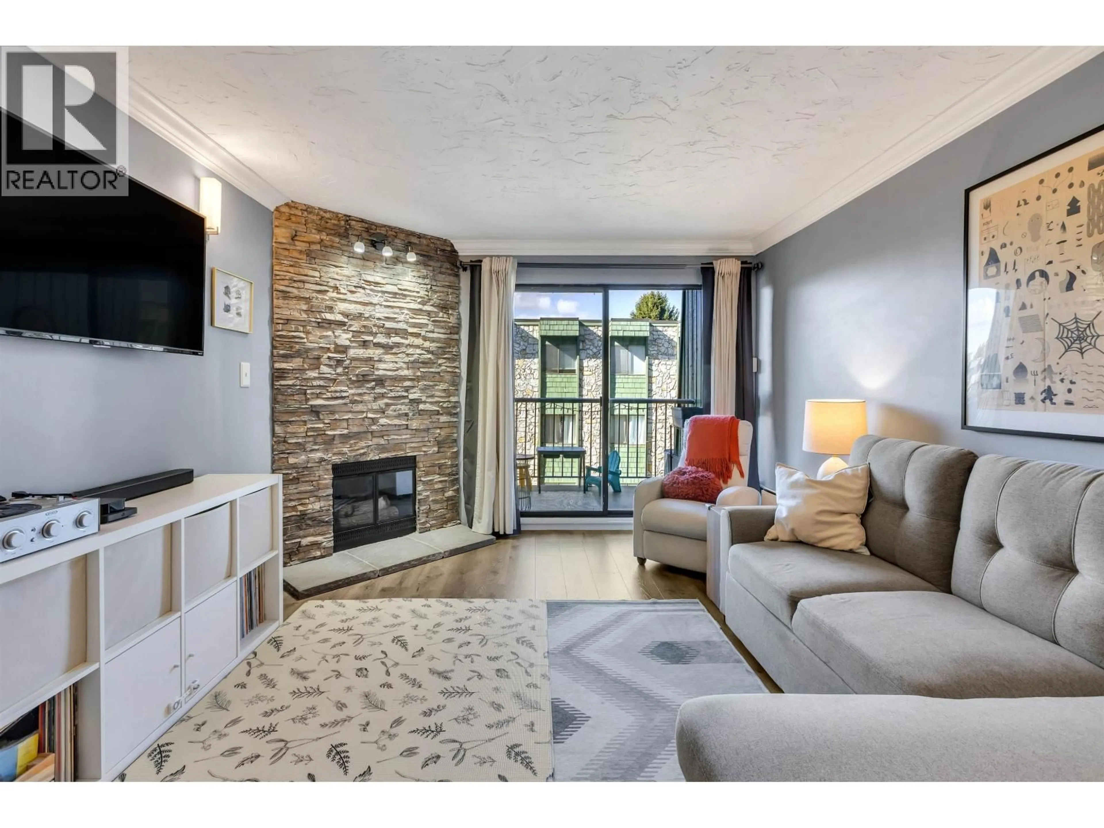 Living room with furniture, ceramic/tile floor for 207 - 3901 CARRIGAN COURT, Burnaby British Columbia V3N4K1