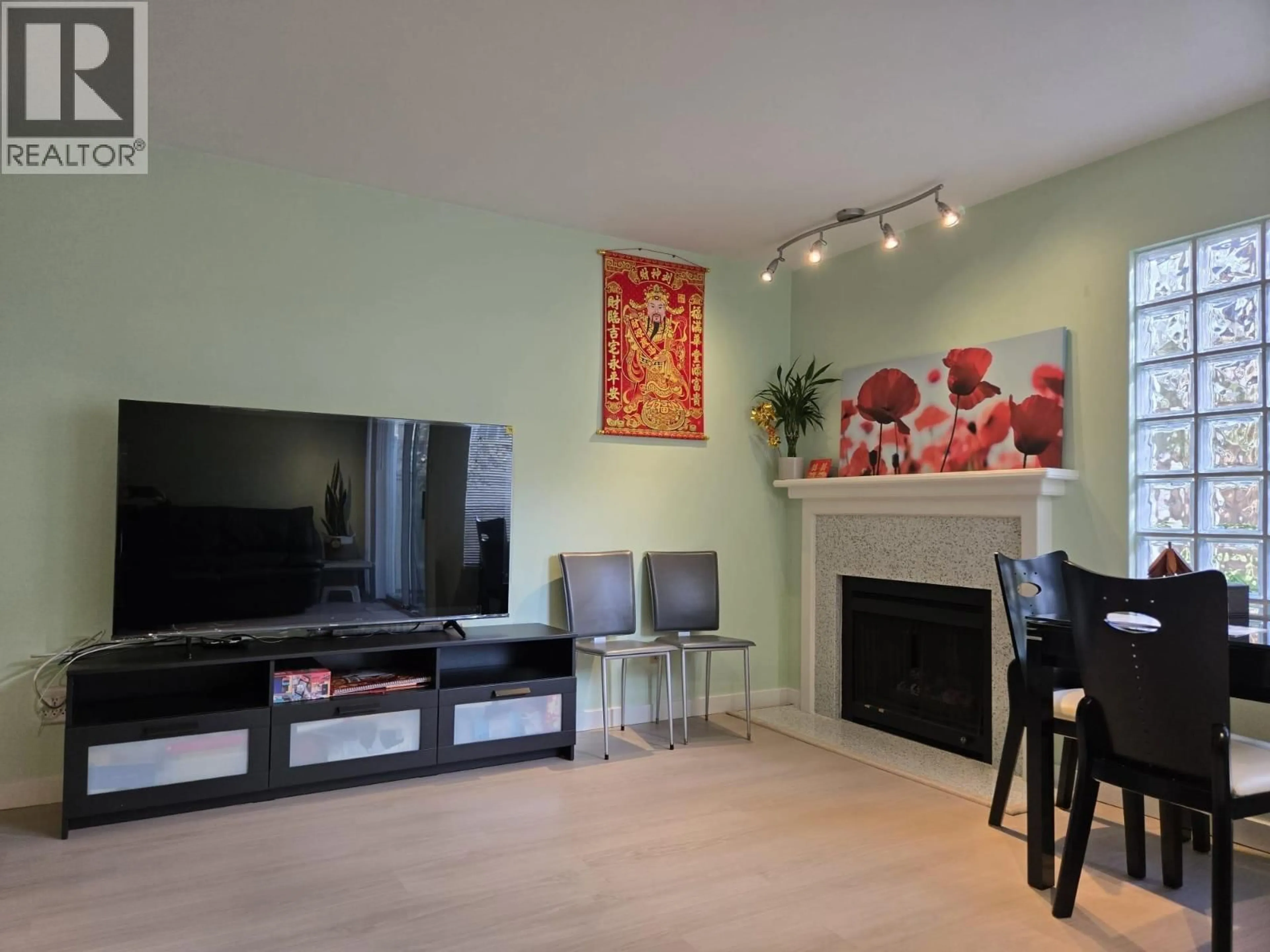 Living room with furniture, wood/laminate floor for 11 - 6391 COONEY ROAD, Richmond British Columbia V6Y2J5