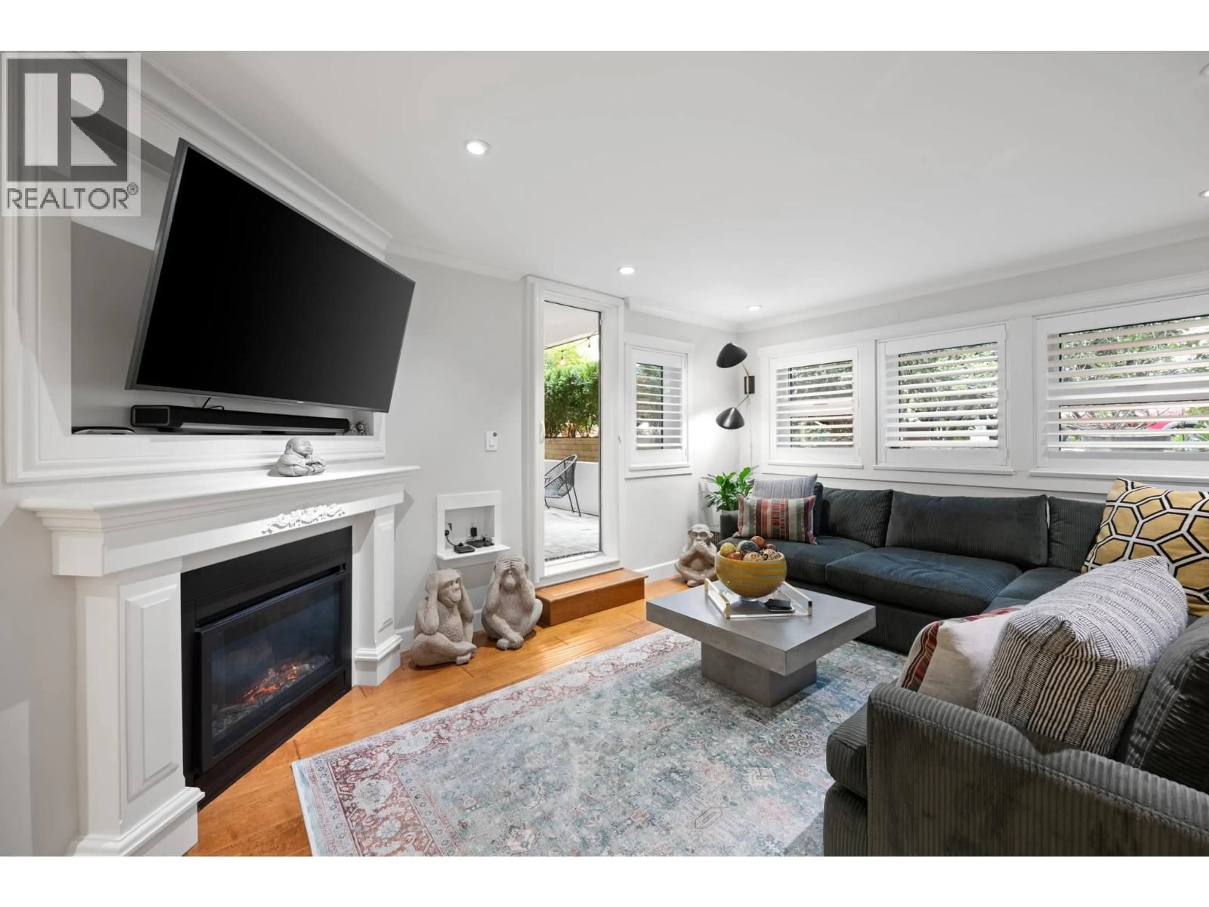 Living room with furniture, wood/laminate floor for 102 - 828 GILFORD STREET, Vancouver British Columbia V6G2N6