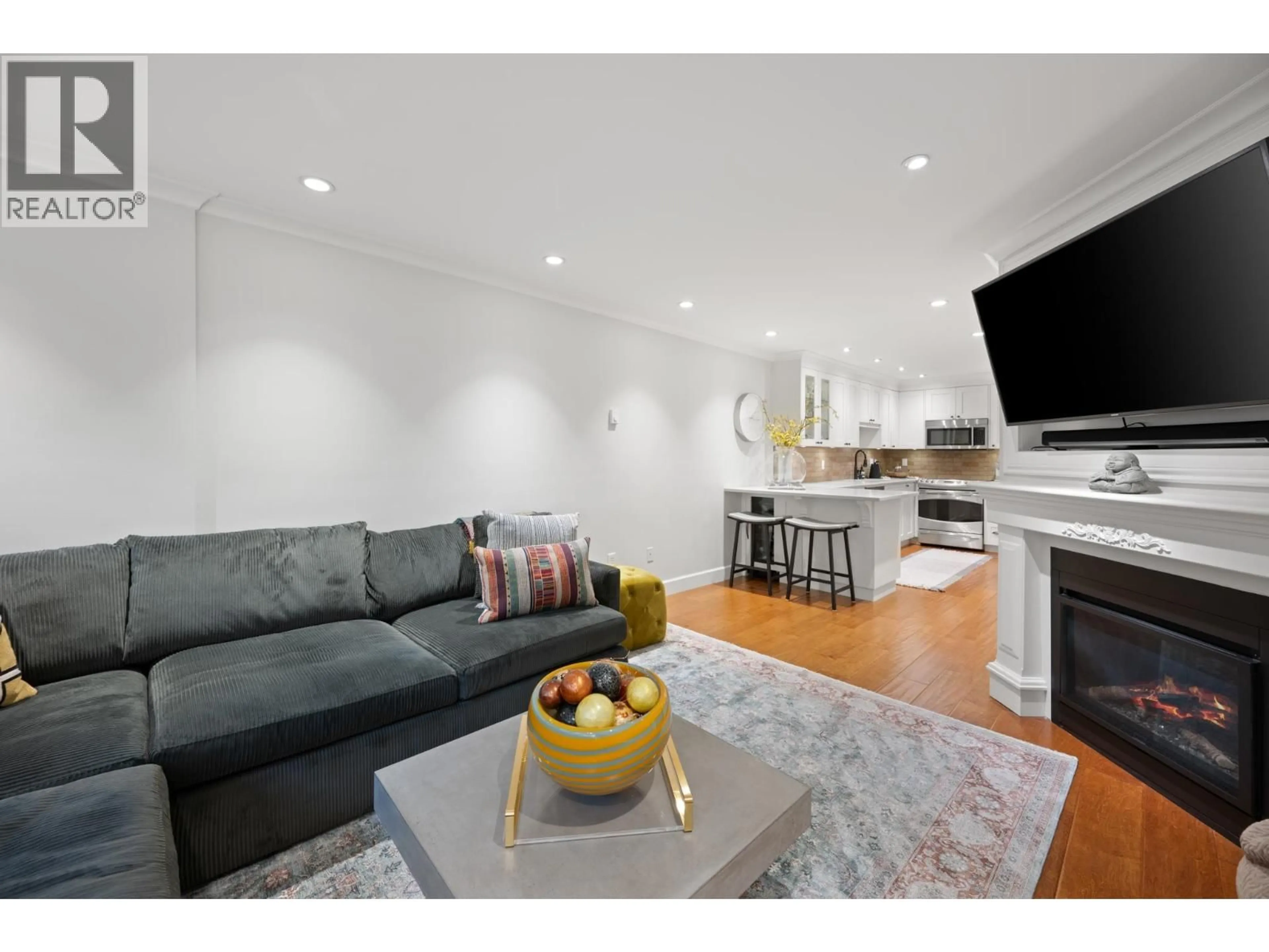 Living room with furniture, wood/laminate floor for 102 - 828 GILFORD STREET, Vancouver British Columbia V6G2N6