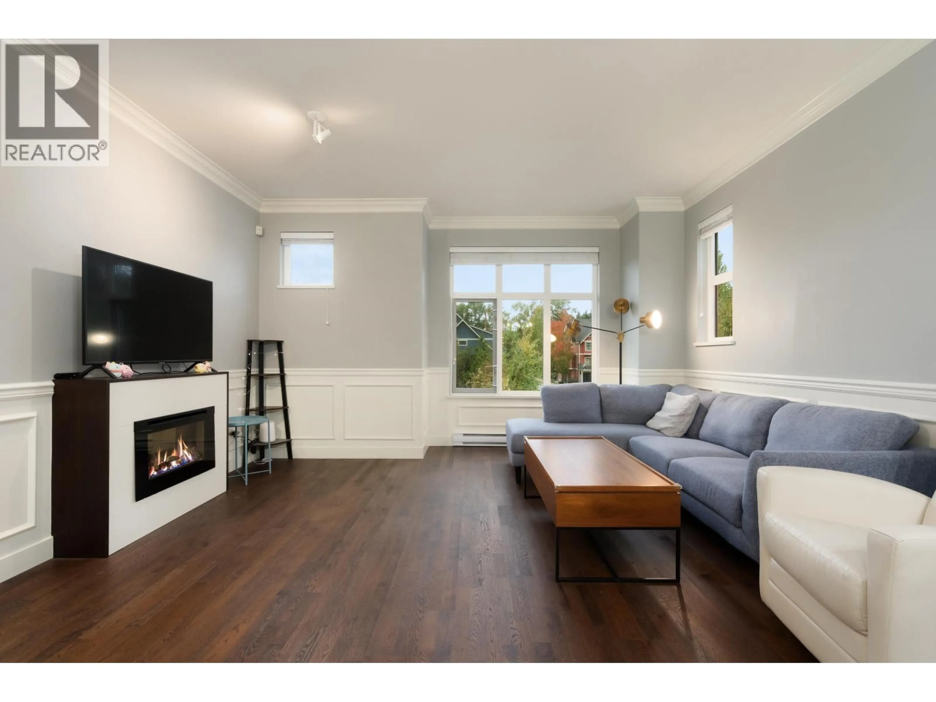 Living room with furniture, wood/laminate floor for 401 - 8485 NEW HAVEN CLOSE, Burnaby British Columbia V5J0B7