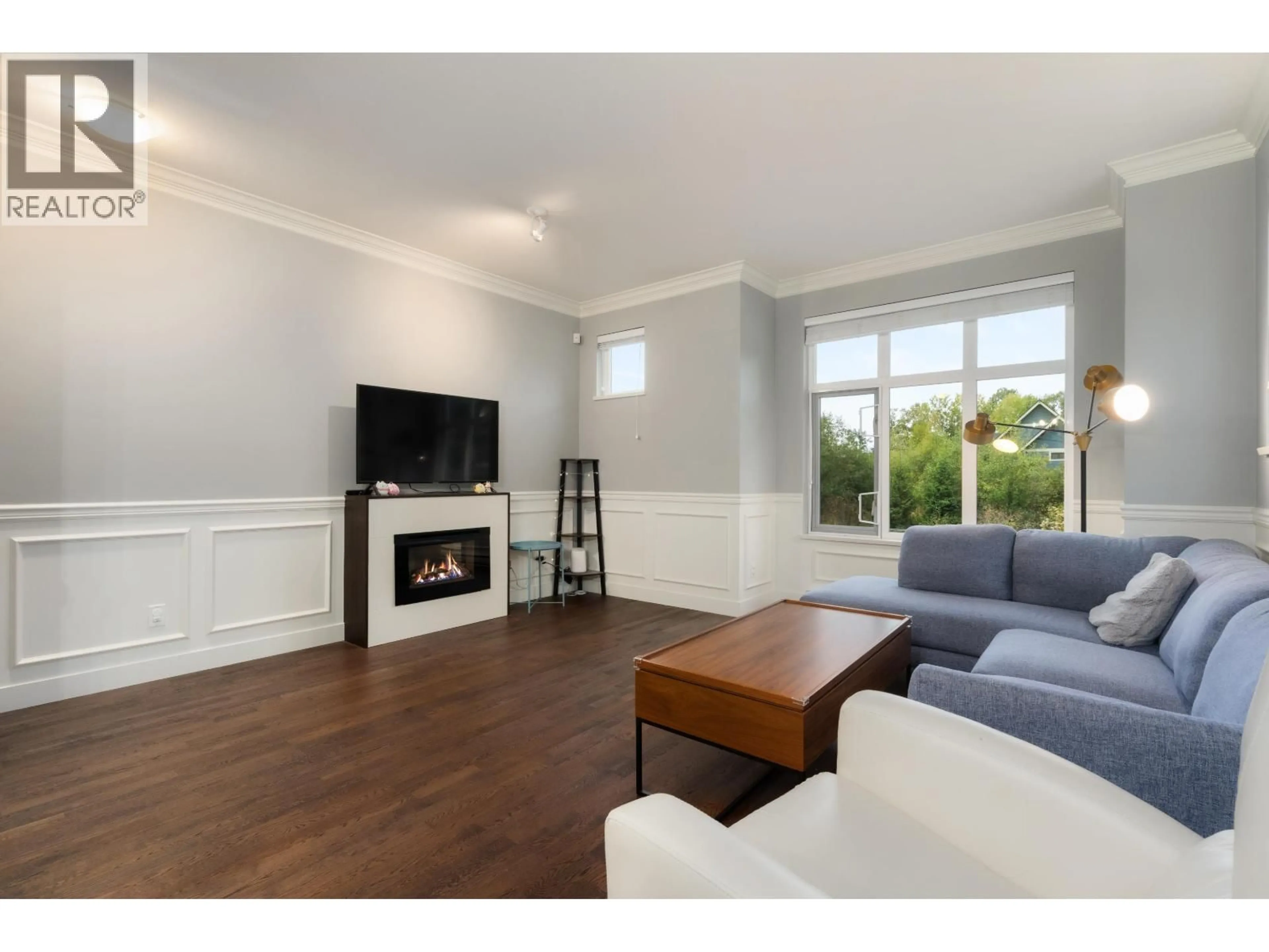 Living room with furniture, wood/laminate floor for 401 - 8485 NEW HAVEN CLOSE, Burnaby British Columbia V5J0B7