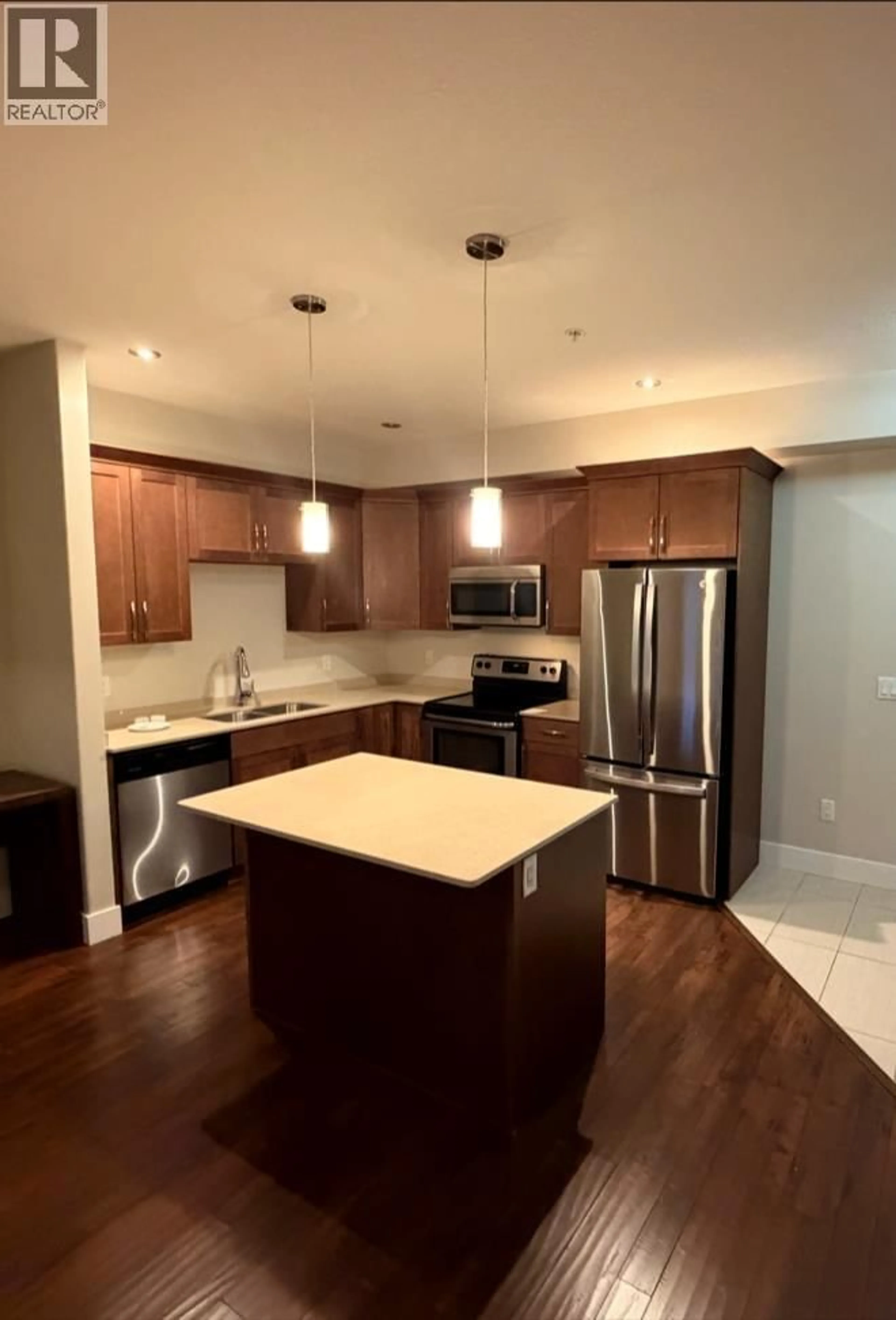 Open concept kitchen, wood/laminate floor for 401 - 11203 105 AVENUE, Fort St. John British Columbia V1J0L3