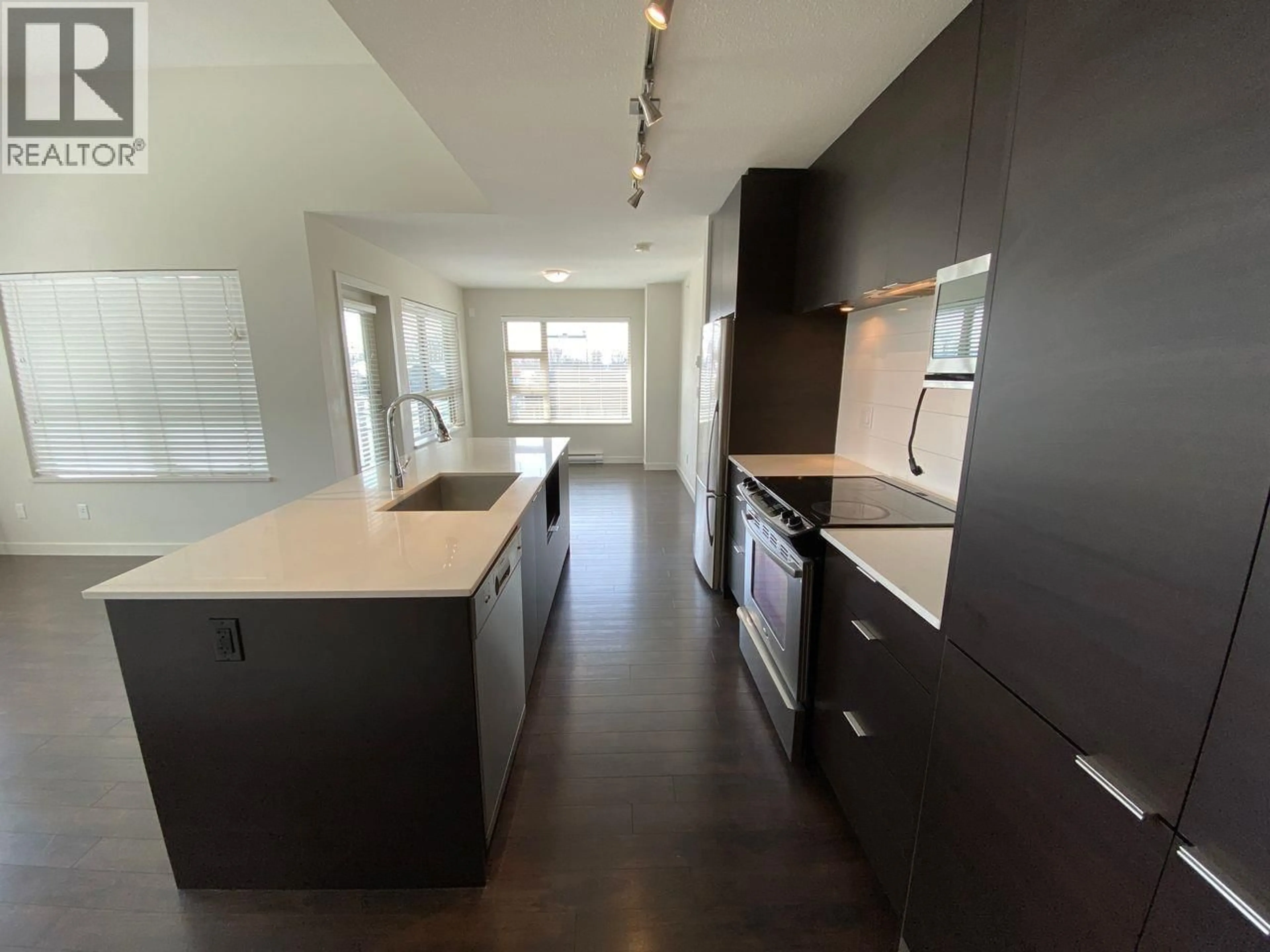 Open concept kitchen, wood/laminate floor for 509 - 1679 LLOYD AVENUE, North Vancouver British Columbia V7P0A9