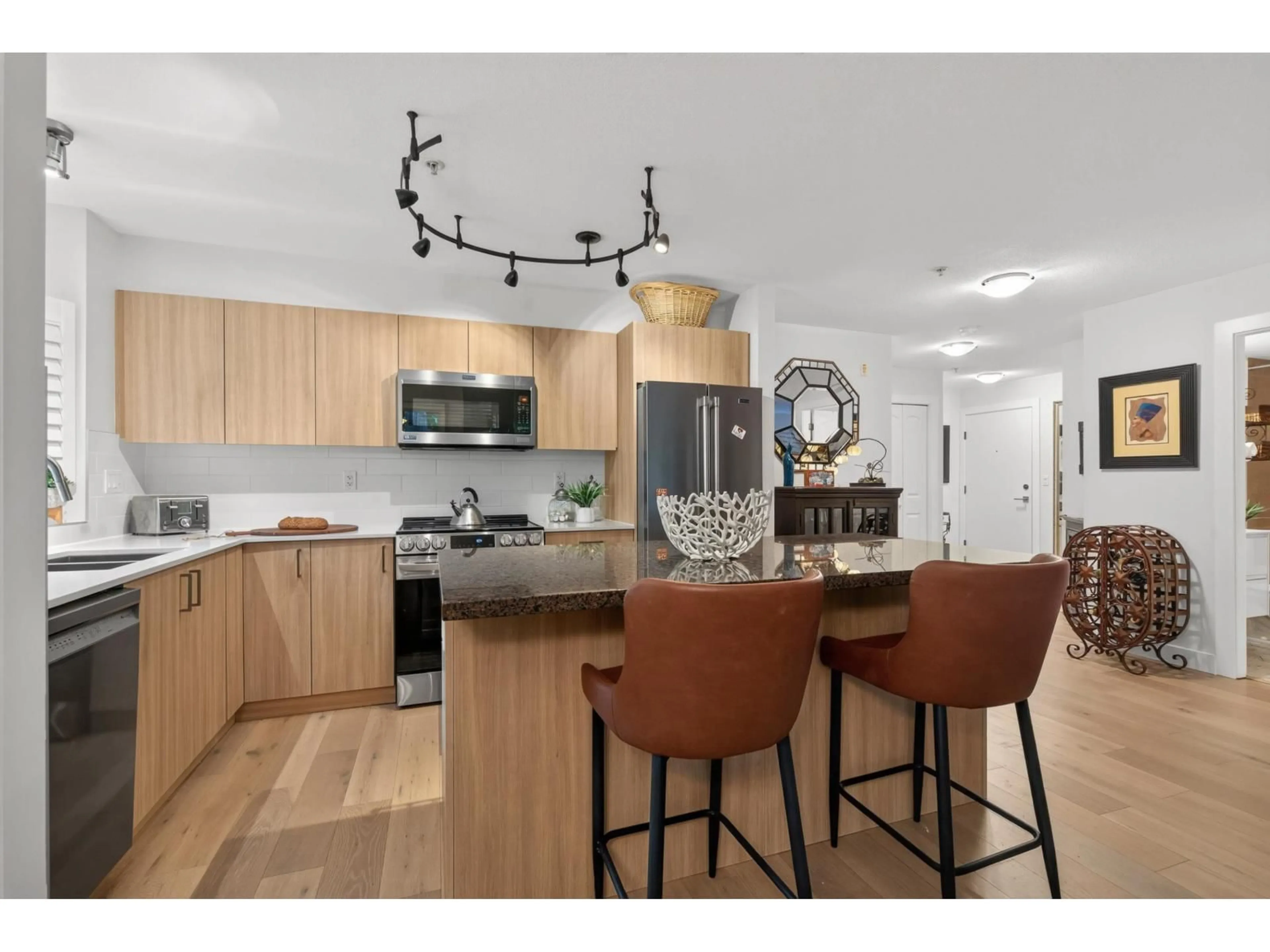 Open concept kitchen, wood/laminate floor for 209 - 8717 160 STREET, Surrey British Columbia V4N5X7