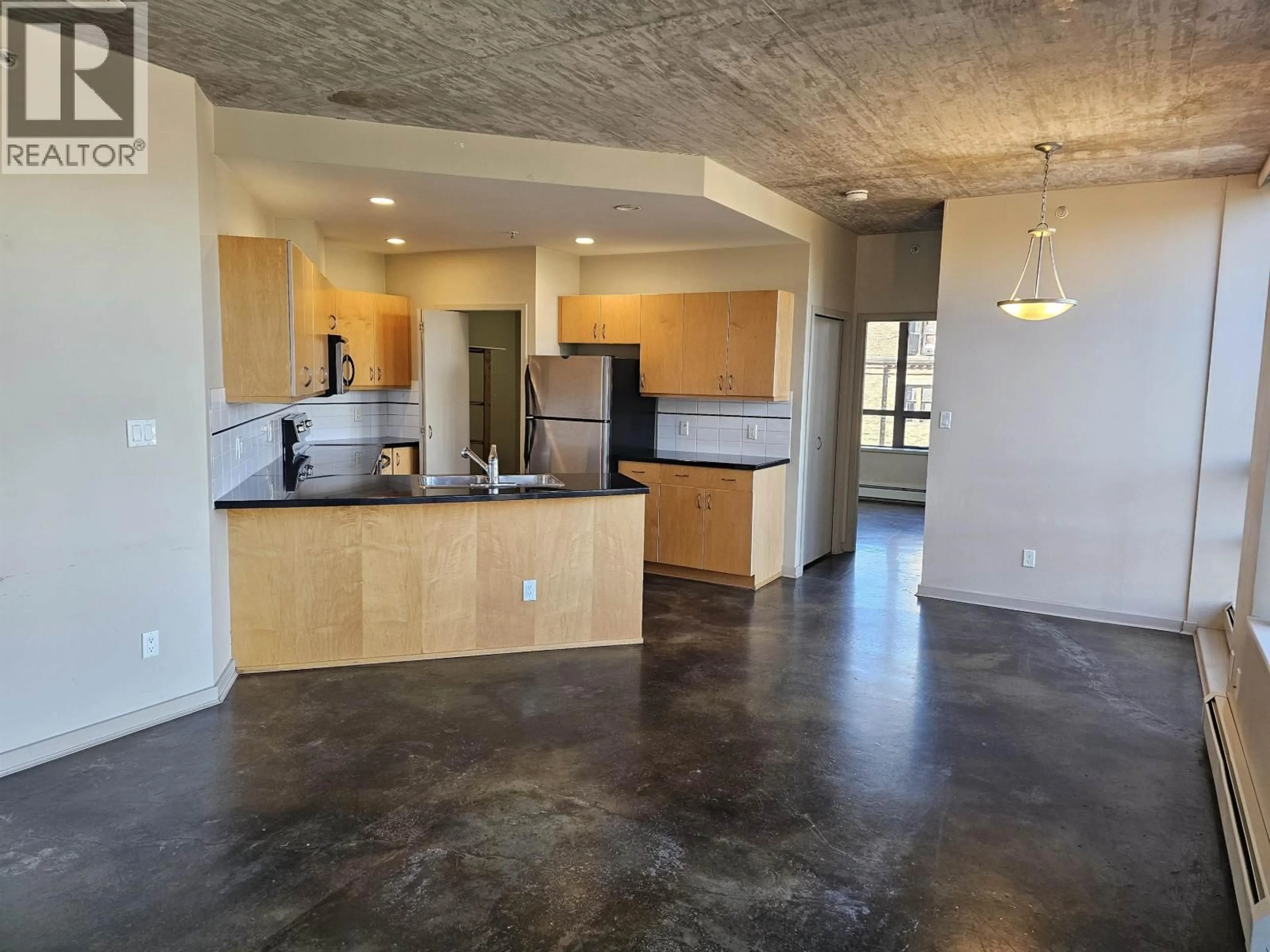 Open concept kitchen, cement floor for 502 - 919 STATION STREET, Vancouver British Columbia V6A4L9