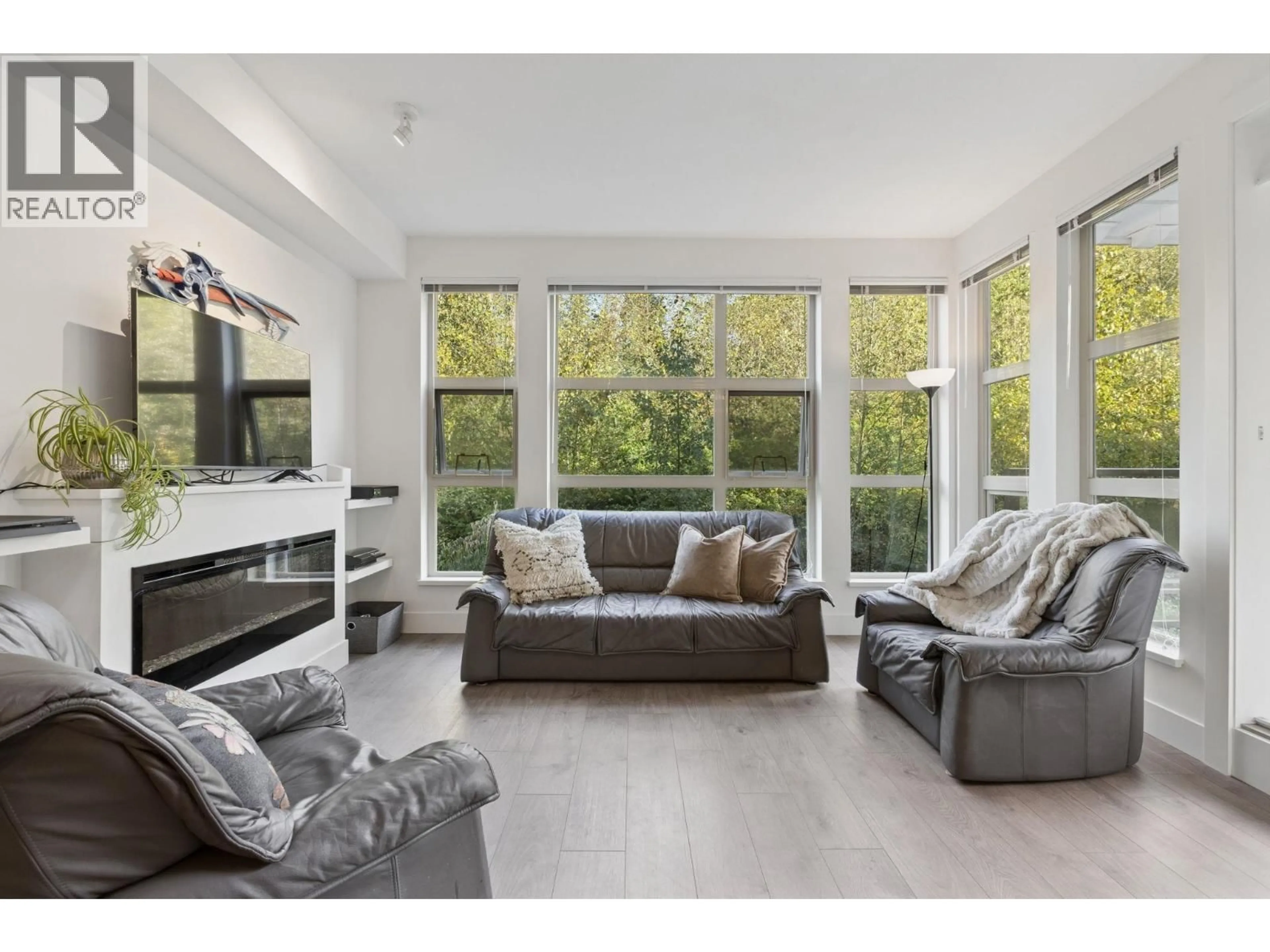 Living room with furniture, wood/laminate floor for 318 - 3602 ALDERCREST DRIVE, North Vancouver British Columbia V7G0A2