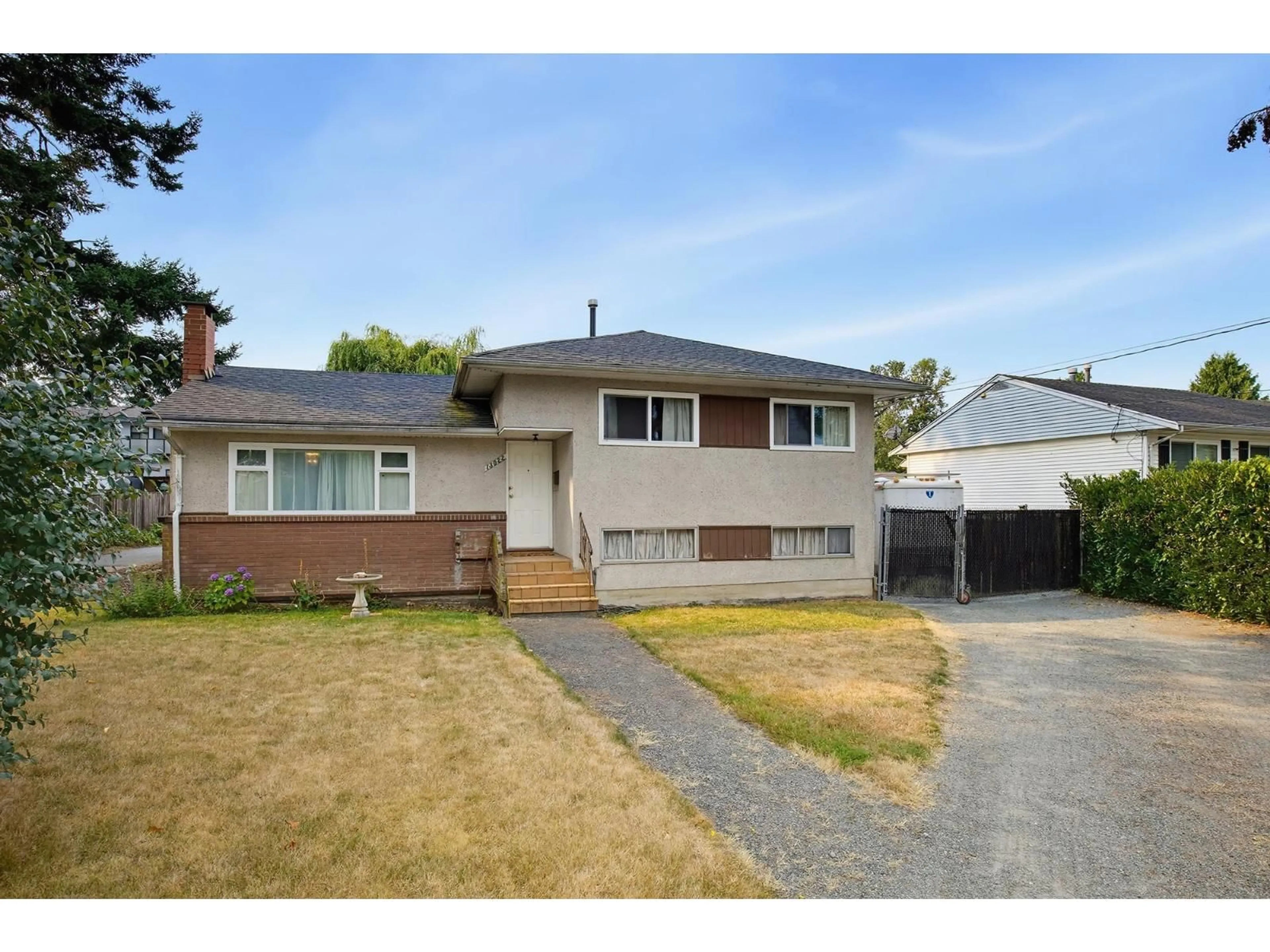 Home with vinyl exterior material, street for 13022 101 AVENUE, Surrey British Columbia V3T1L1