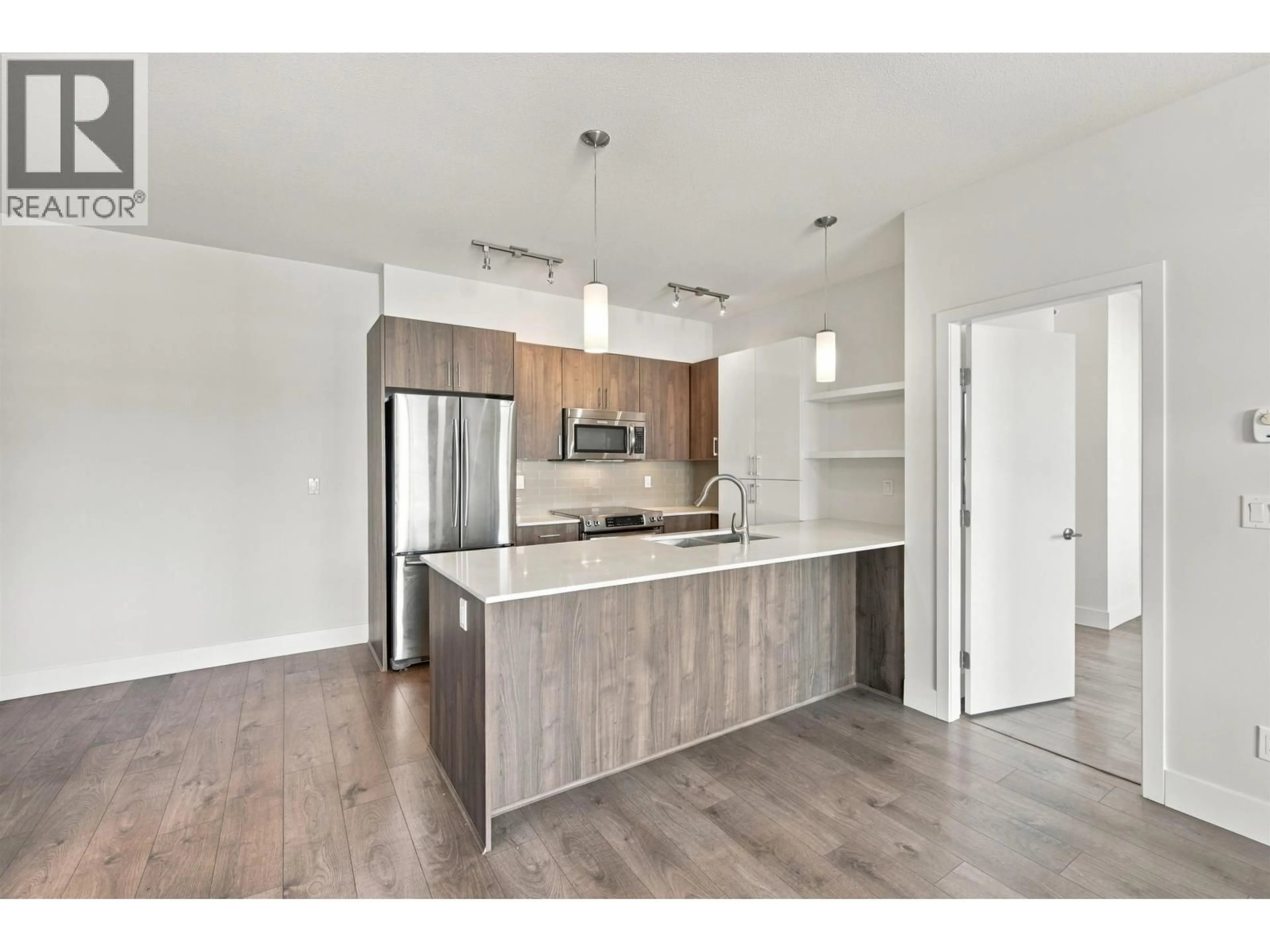 Open concept kitchen, wood/laminate floor for 410 - 630 COMO LAKE AVENUE, Coquitlam British Columbia V3J0E4