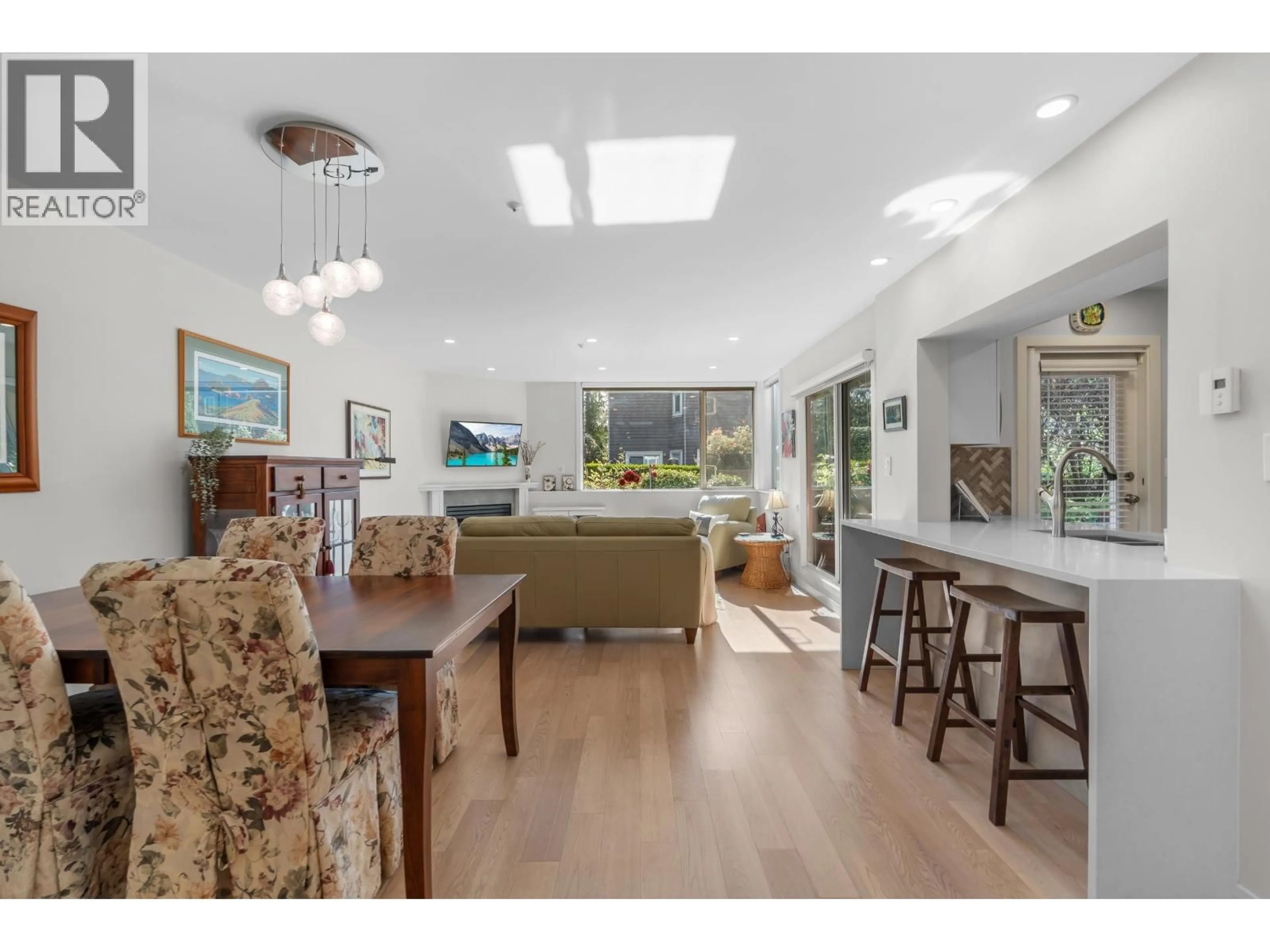 Open concept kitchen, wood/laminate floor for 112 - 8450 JELLICOE STREET, Vancouver British Columbia V5S4S9