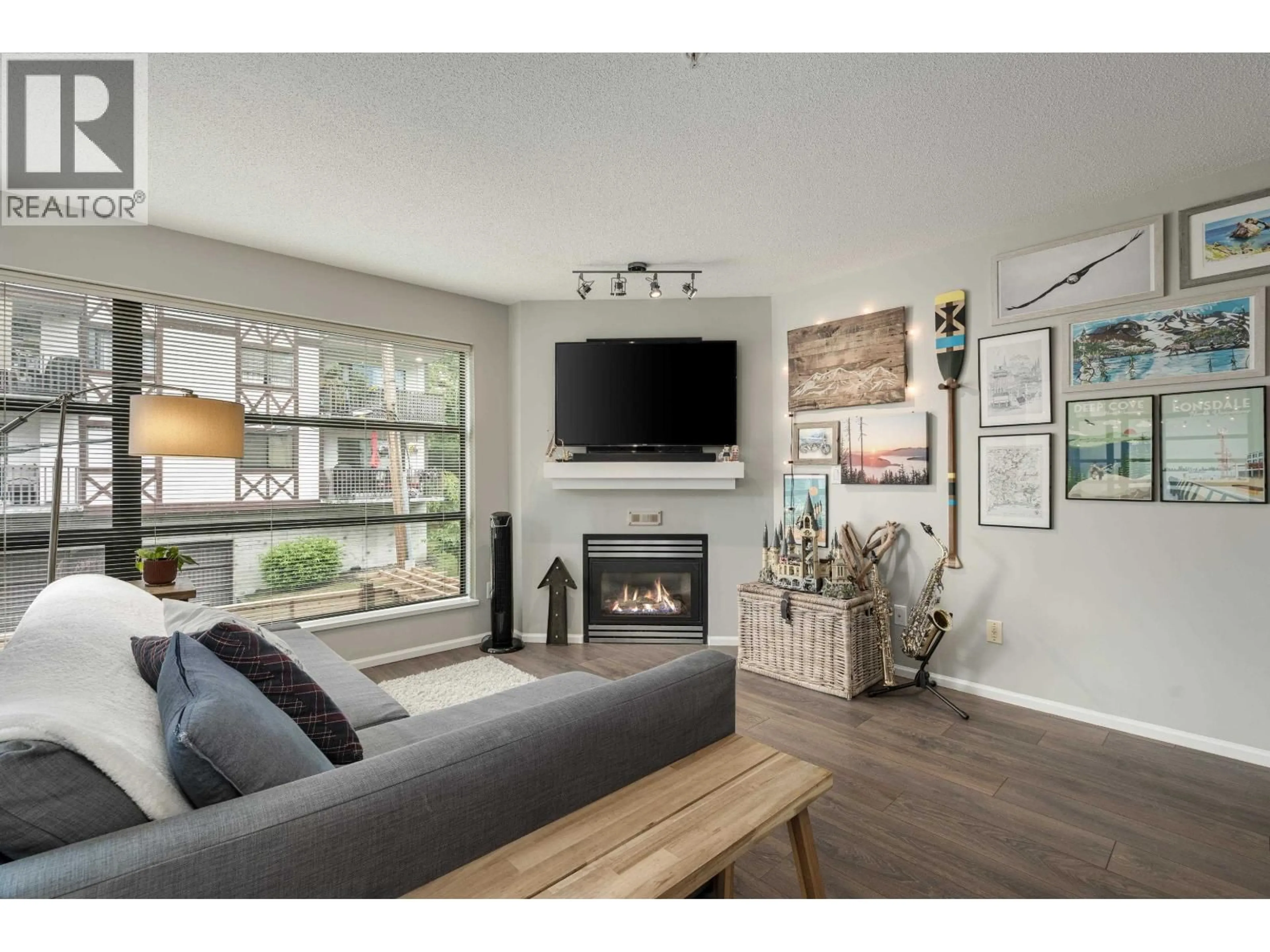 Living room with furniture, wood/laminate floor for 305 - 124 3RD STREET, North Vancouver British Columbia V7M1E8