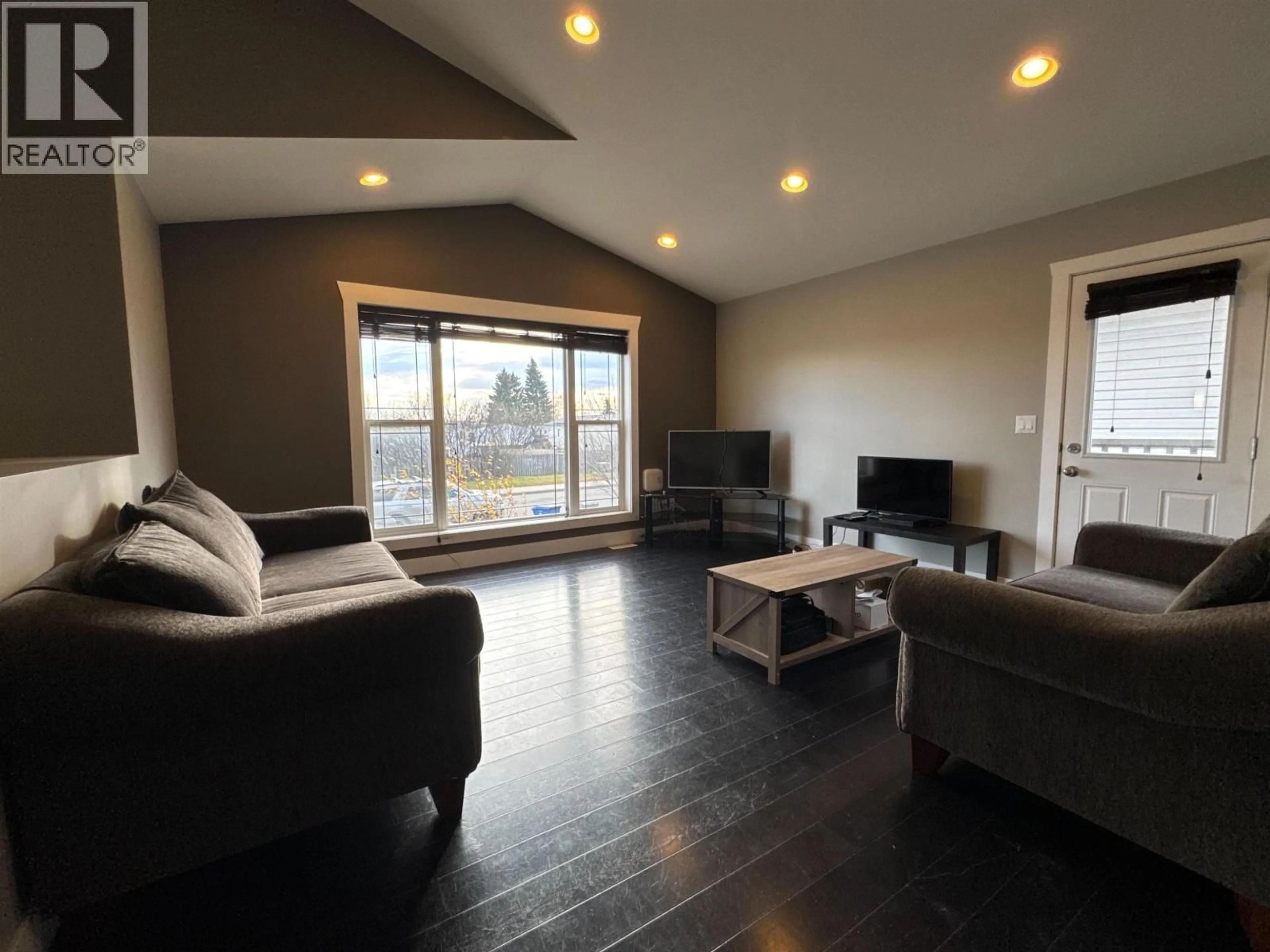 Living room with furniture, wood/laminate floor for 8312 85 AVENUE, Fort St. John British Columbia V1J0G3