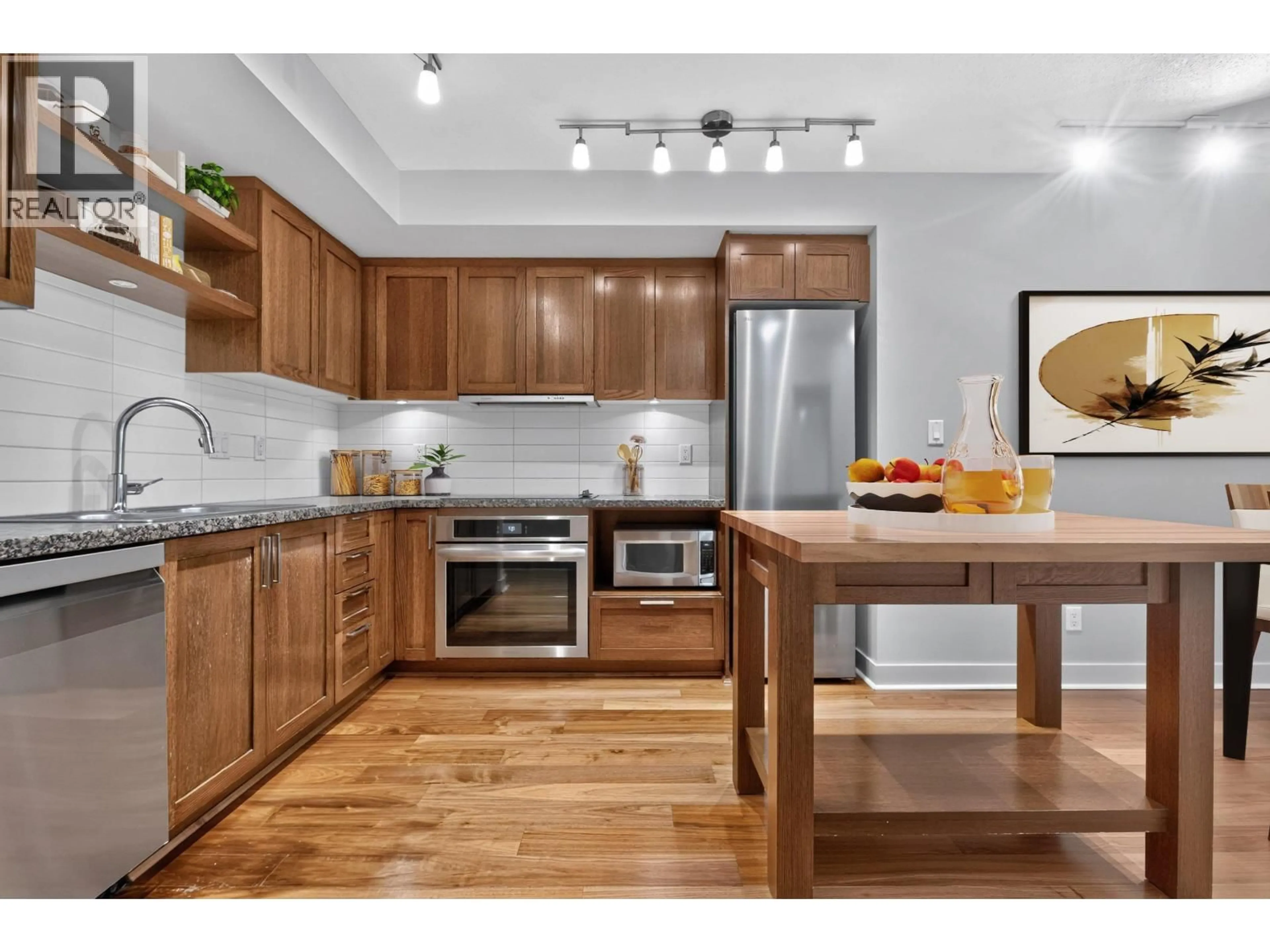 Open concept kitchen, wood/laminate floor for 314 - 2268 BROADWAY, Vancouver British Columbia V6K0B1