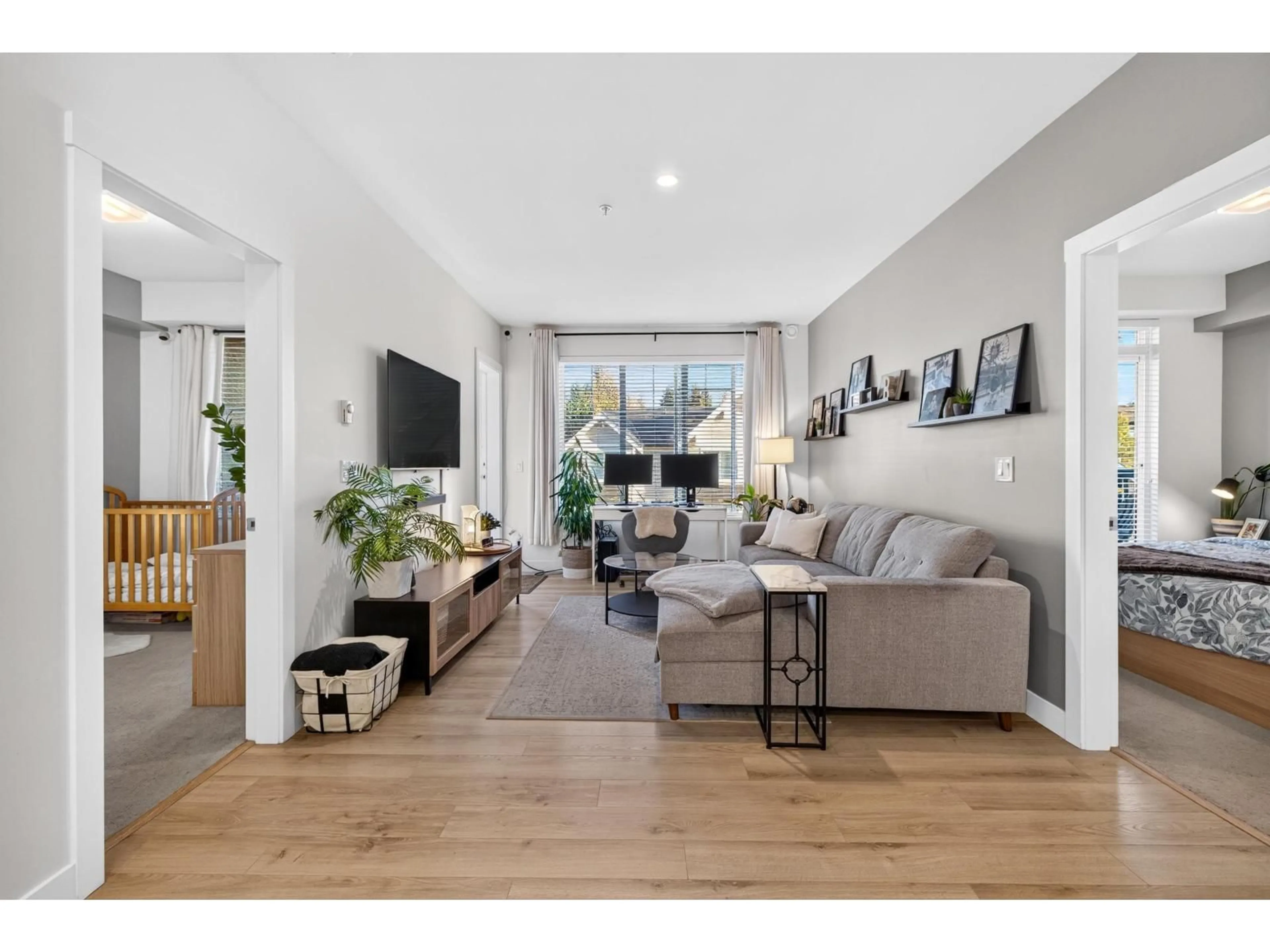 Living room with furniture, wood/laminate floor for B306 - 20487 65 AVENUE, Langley British Columbia V2Y3K5