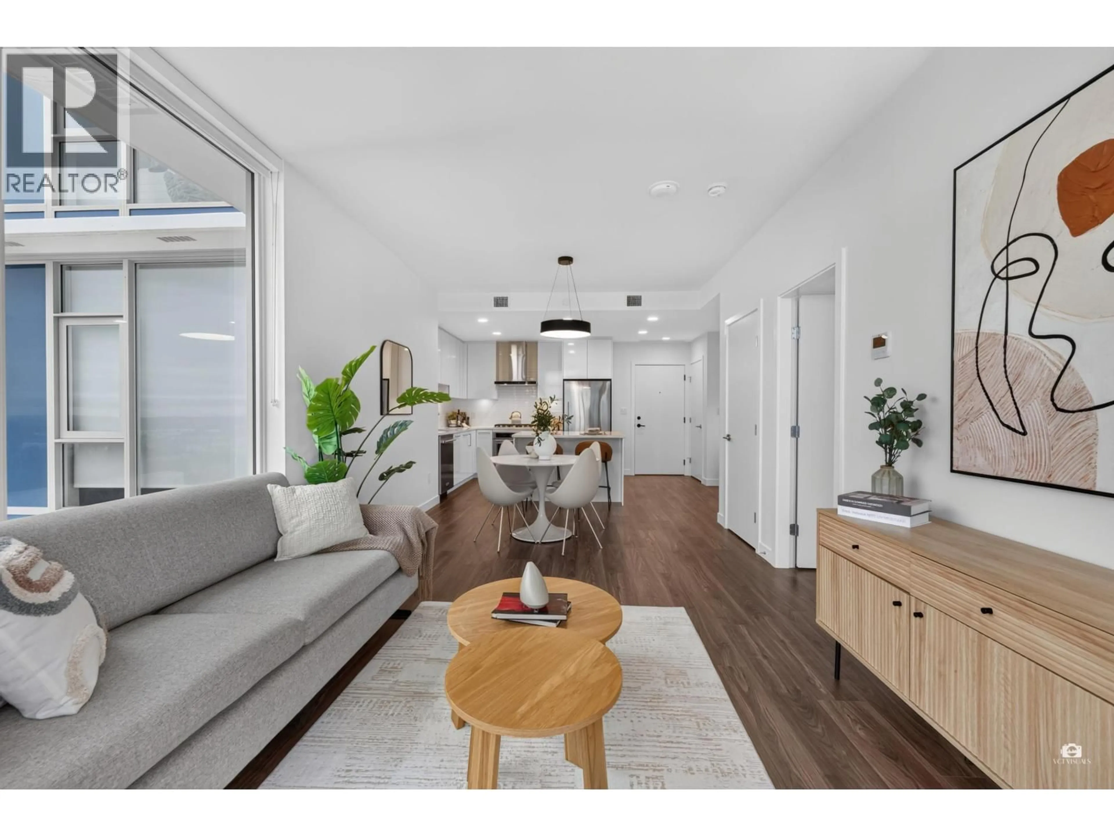 Living room with furniture, wood/laminate floor for 2207 - 518 CLARKE ROAD, Coquitlam British Columbia V3J3X2
