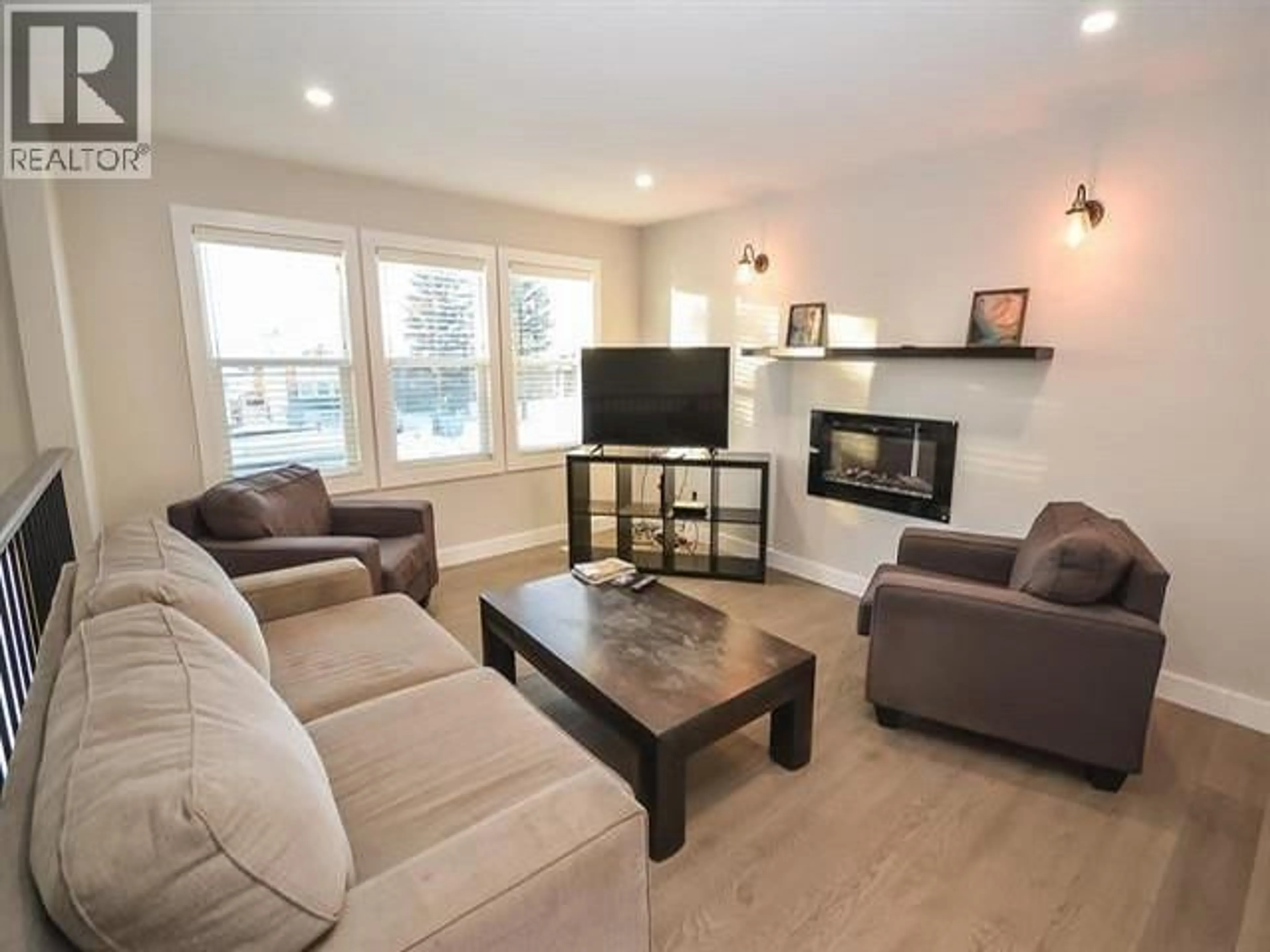 Living room with furniture, wood/laminate floor for 8923 87 STREET, Fort St. John British Columbia V1J5H3