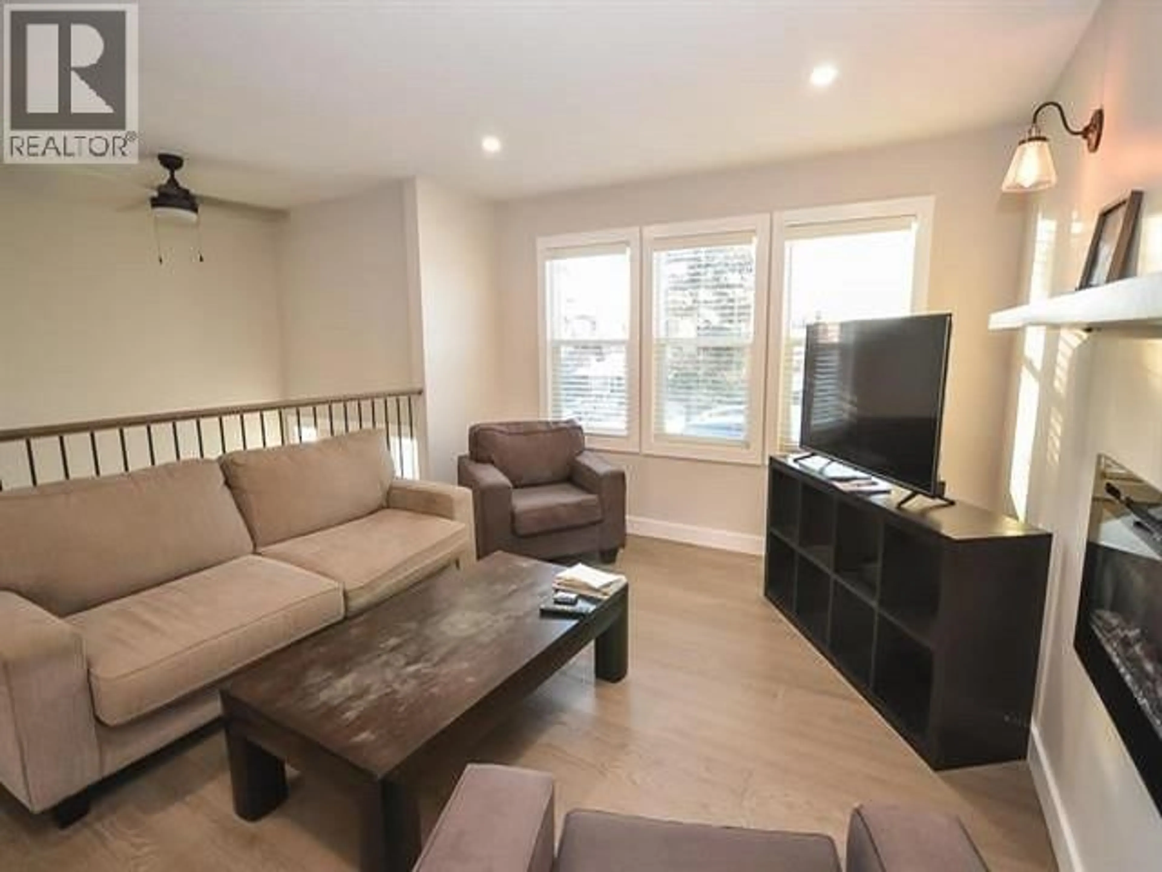Living room with furniture, wood/laminate floor for 8923 87 STREET, Fort St. John British Columbia V1J5H3