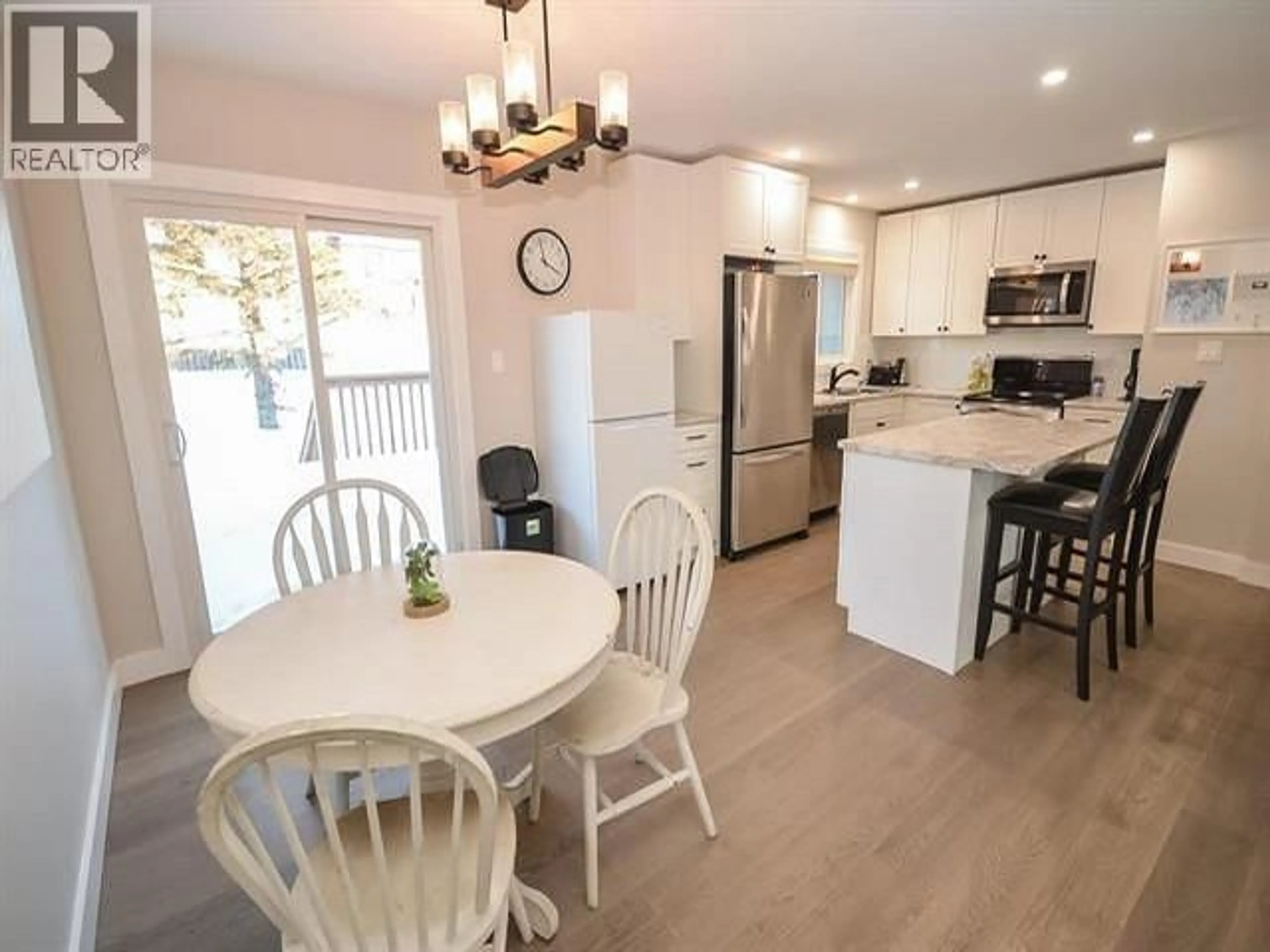 Open concept kitchen, wood/laminate floor for 8923 87 STREET, Fort St. John British Columbia V1J5H3