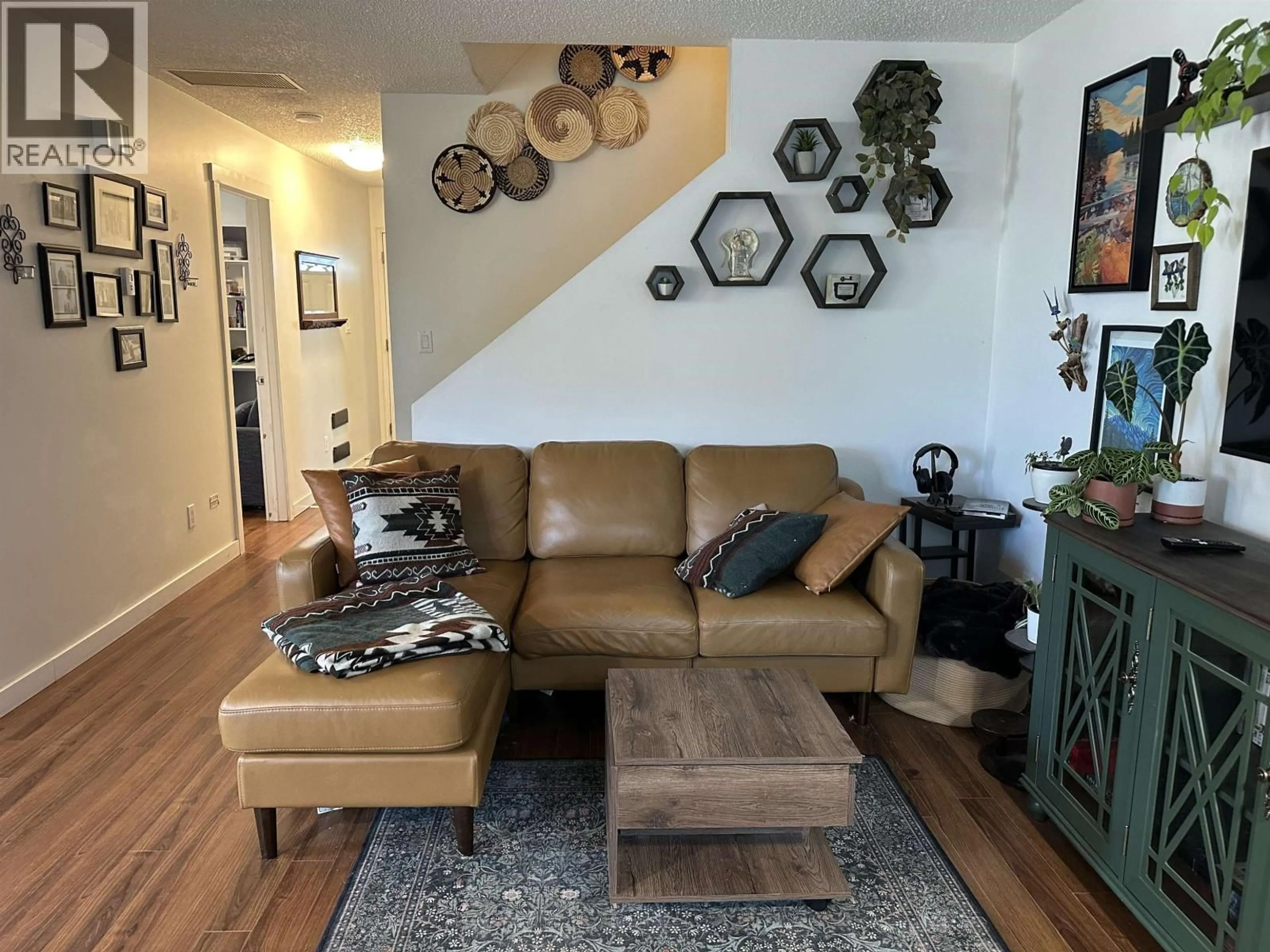 Living room with furniture, wood/laminate floor for 10406 88A STREET, Fort St. John British Columbia V1J5X7