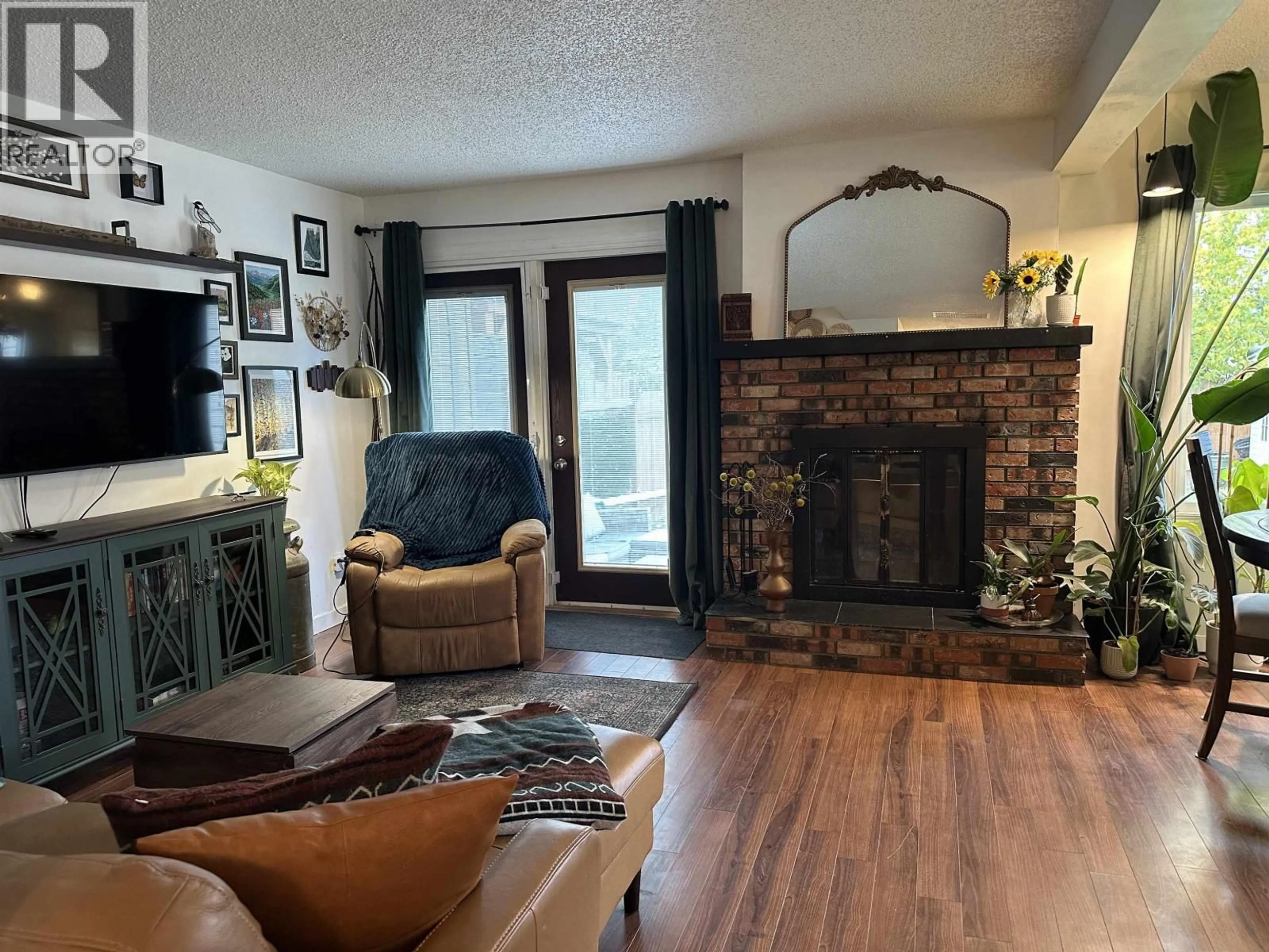Living room with furniture, wood/laminate floor for 10406 88A STREET, Fort St. John British Columbia V1J5X7