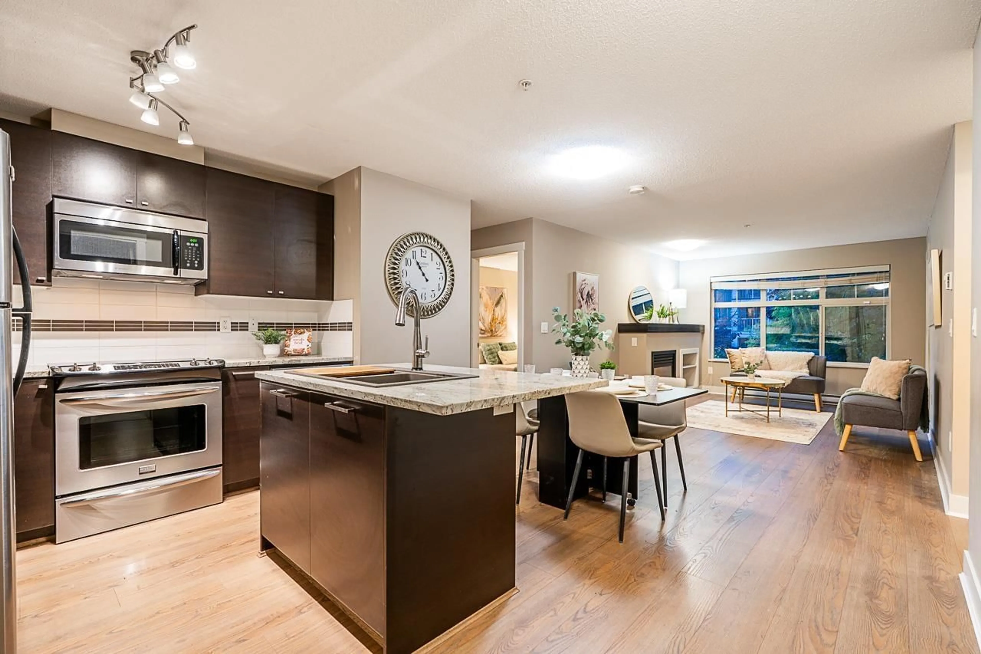 Open concept kitchen, wood/laminate floor for 216 - 6500 194 STREET, Surrey British Columbia V4N5X4