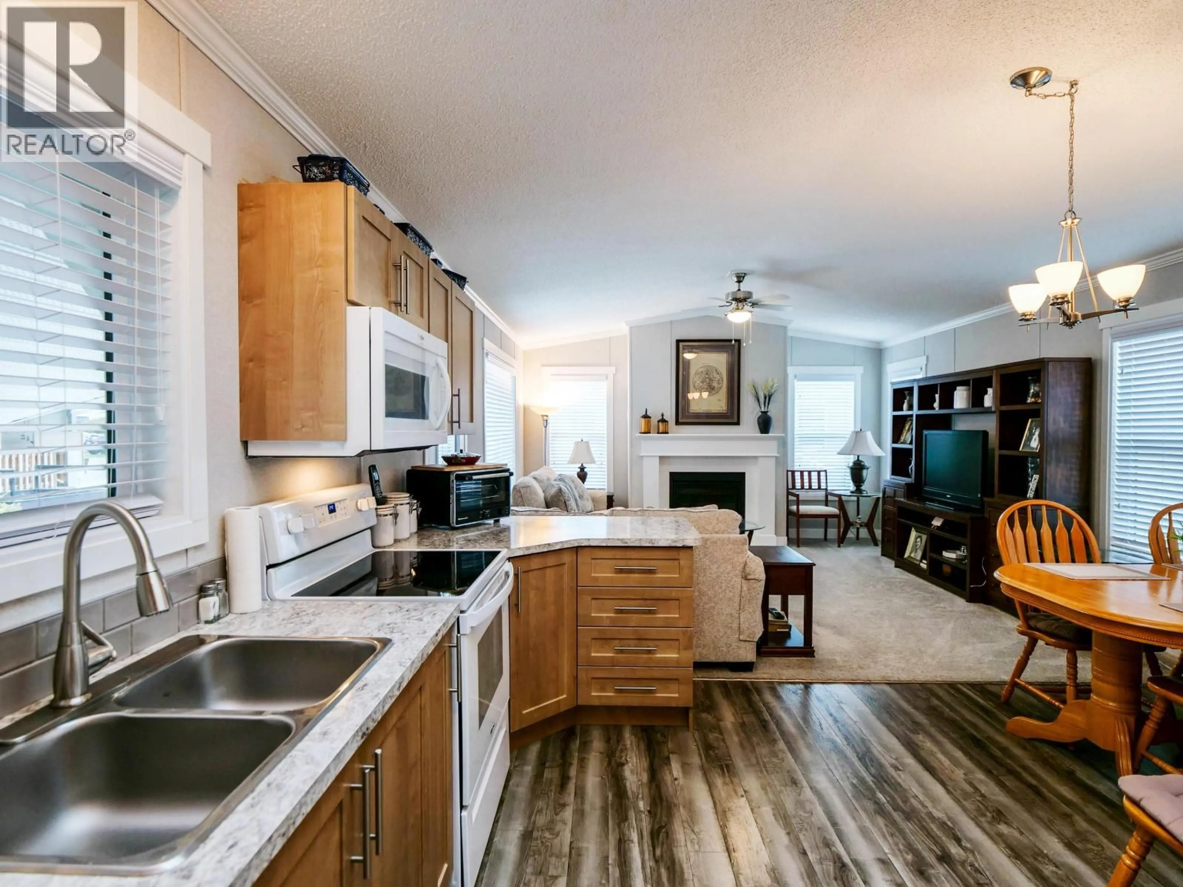 Open concept kitchen, wood/laminate floor for 273 KEROUAC ROAD, Quesnel British Columbia V2J7A2