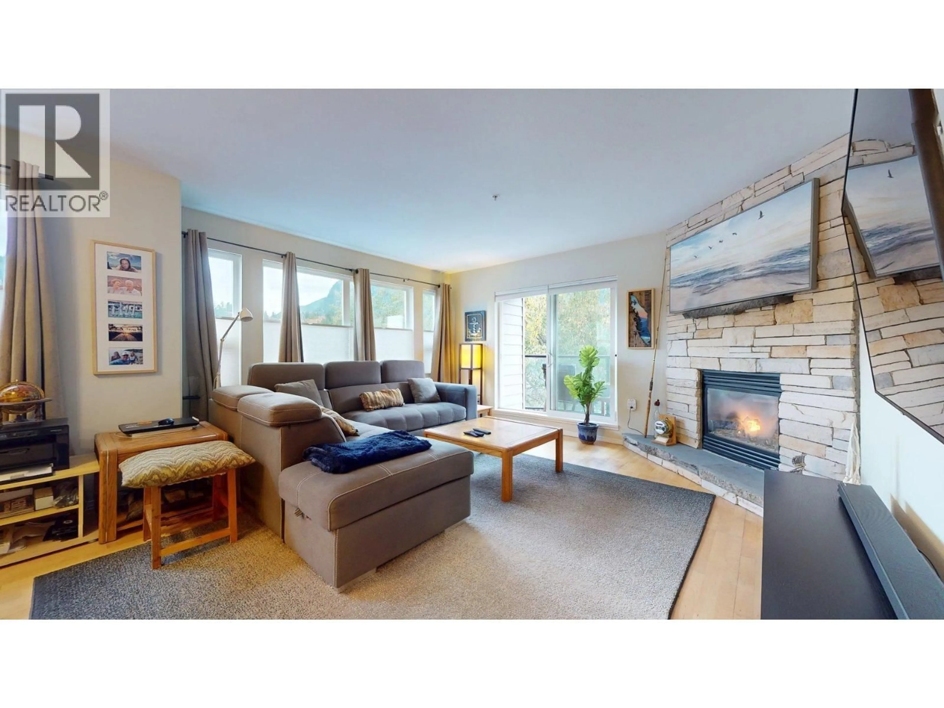 Living room with furniture, wood/laminate floor for 201 - 1468 PEMBERTON AVENUE, Squamish British Columbia V8B0K2