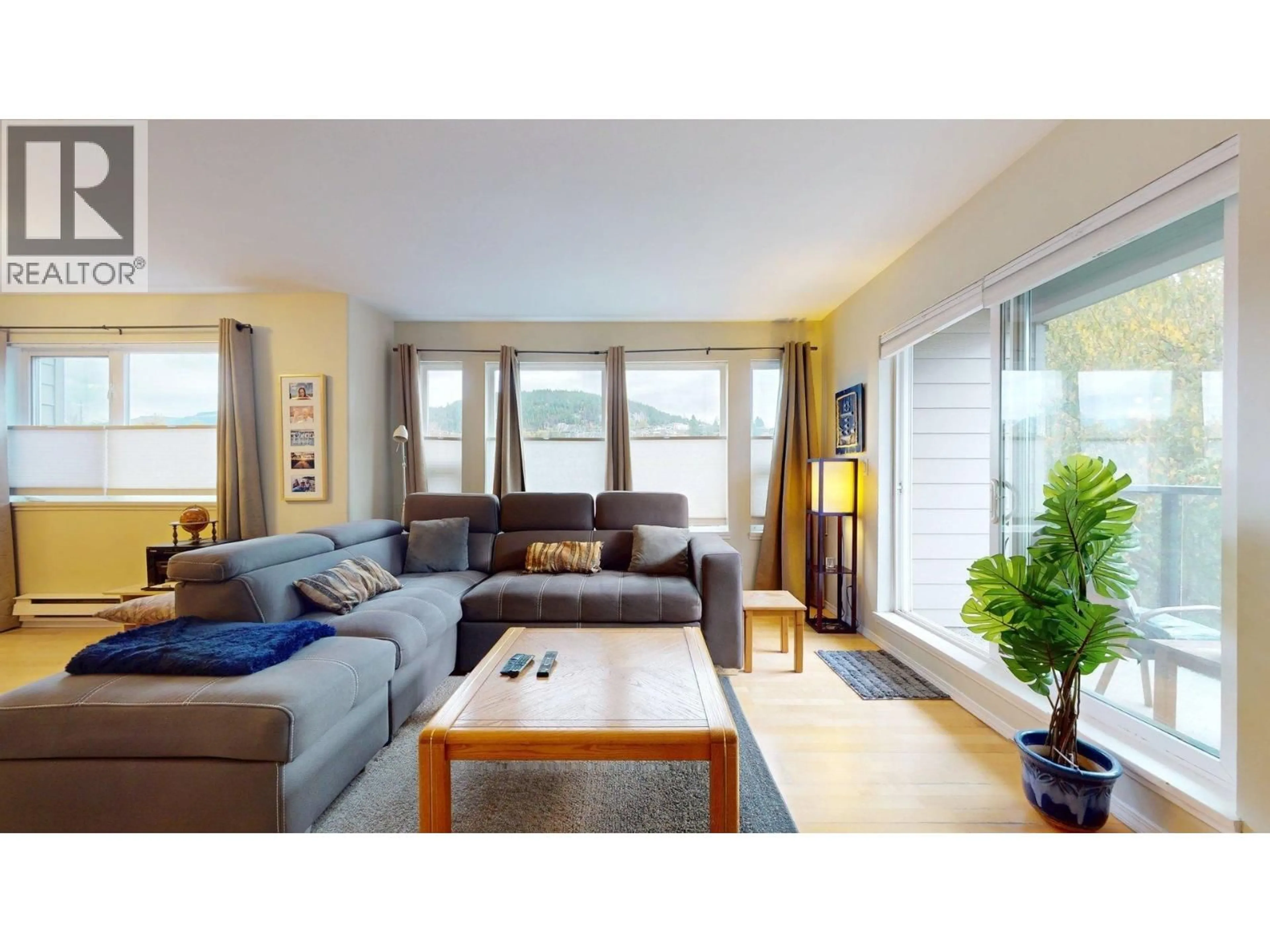 Living room with furniture, wood/laminate floor for 201 - 1468 PEMBERTON AVENUE, Squamish British Columbia V8B0K2