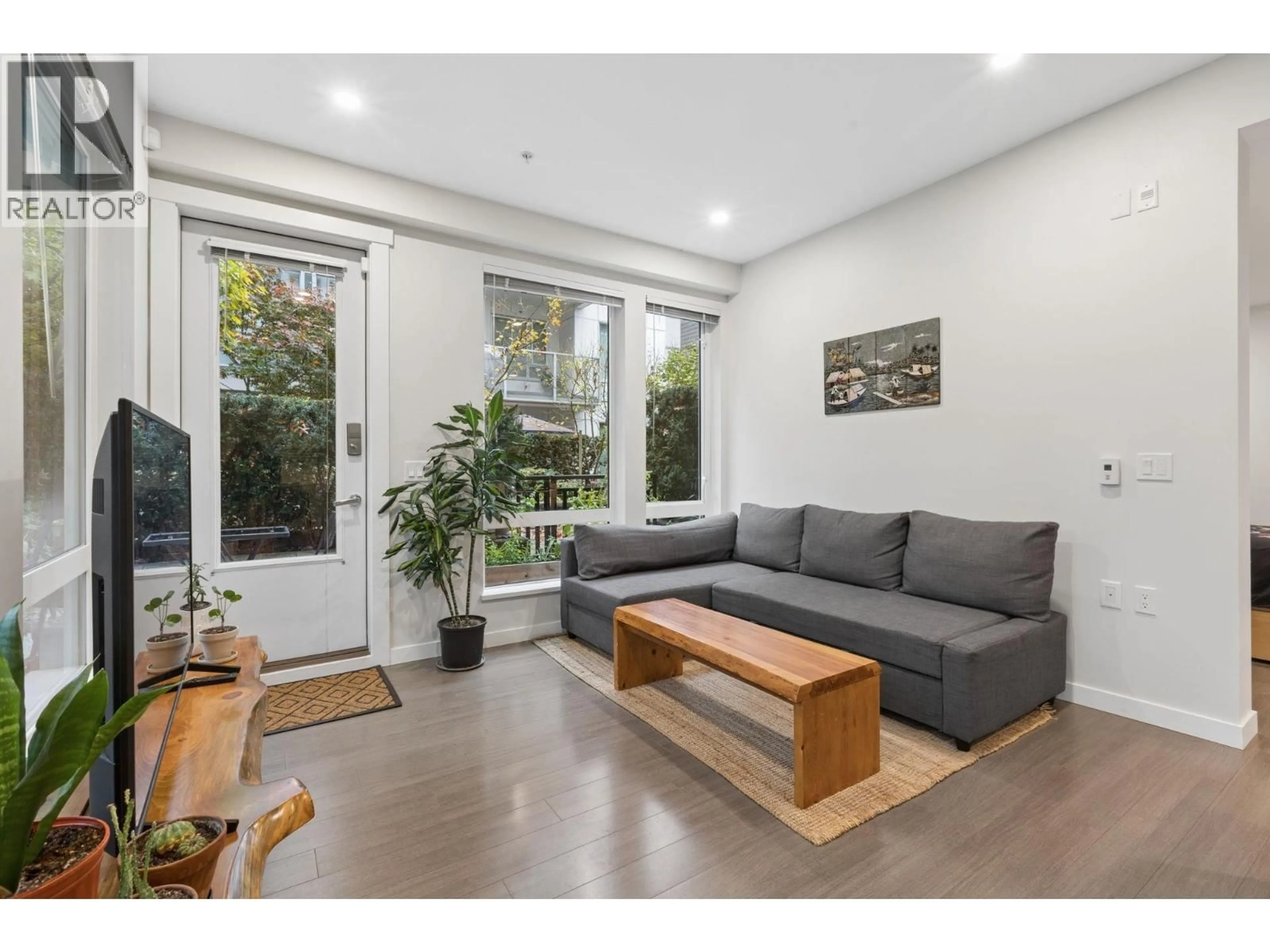 Living room with furniture, wood/laminate floor for 113 - 277 1ST STREET, North Vancouver British Columbia V7M0E8
