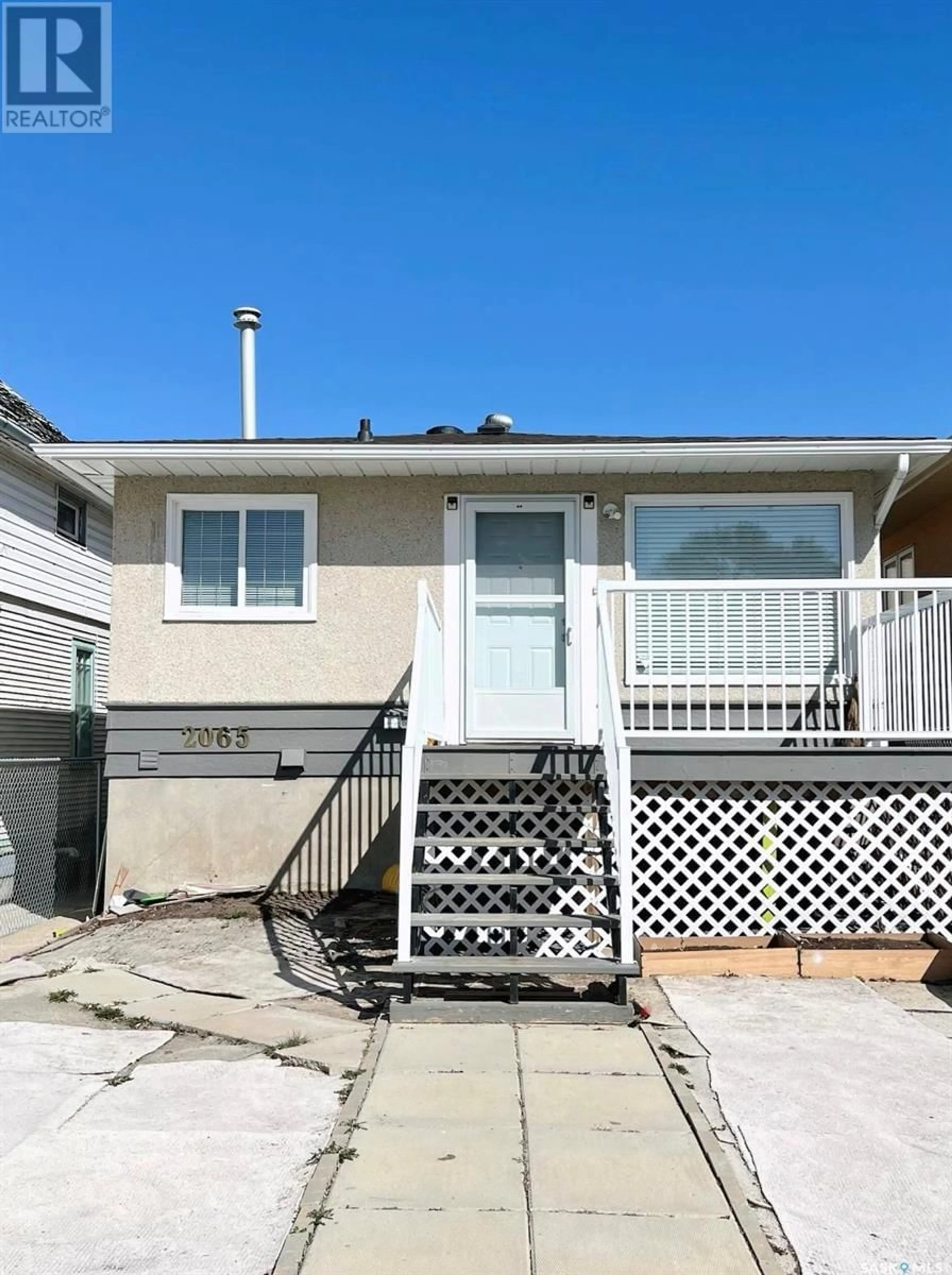 Home with vinyl exterior material, street for 2065 BRODER STREET, Regina Saskatchewan S4N3S3