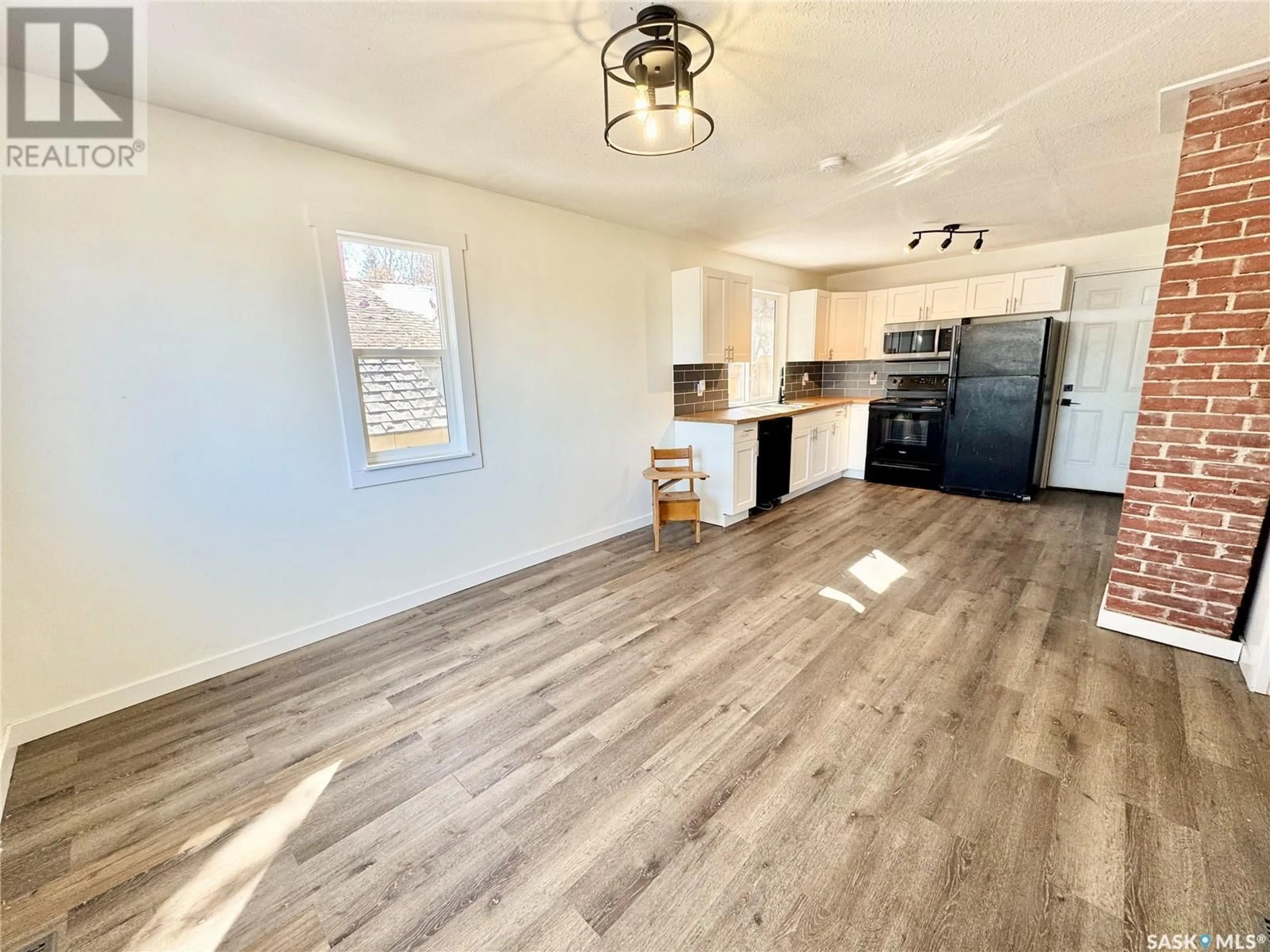 Open concept kitchen, wood/laminate floor for 685 18TH STREET, Prince Albert Saskatchewan S6V4A7
