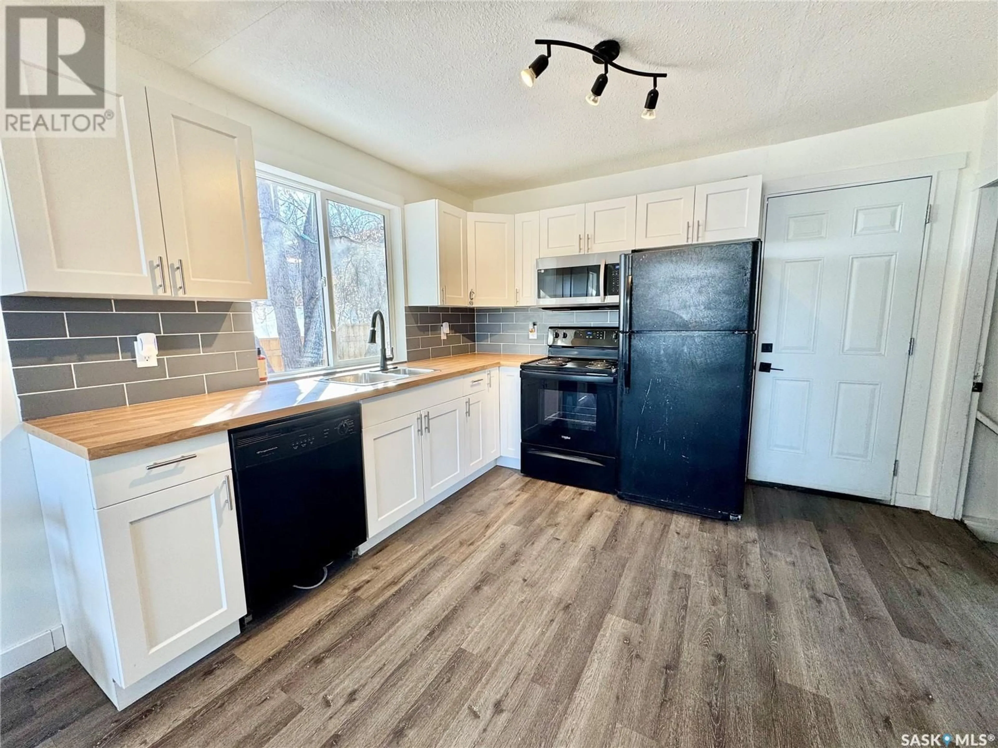 Open concept kitchen, wood/laminate floor for 685 18TH STREET, Prince Albert Saskatchewan S6V4A7