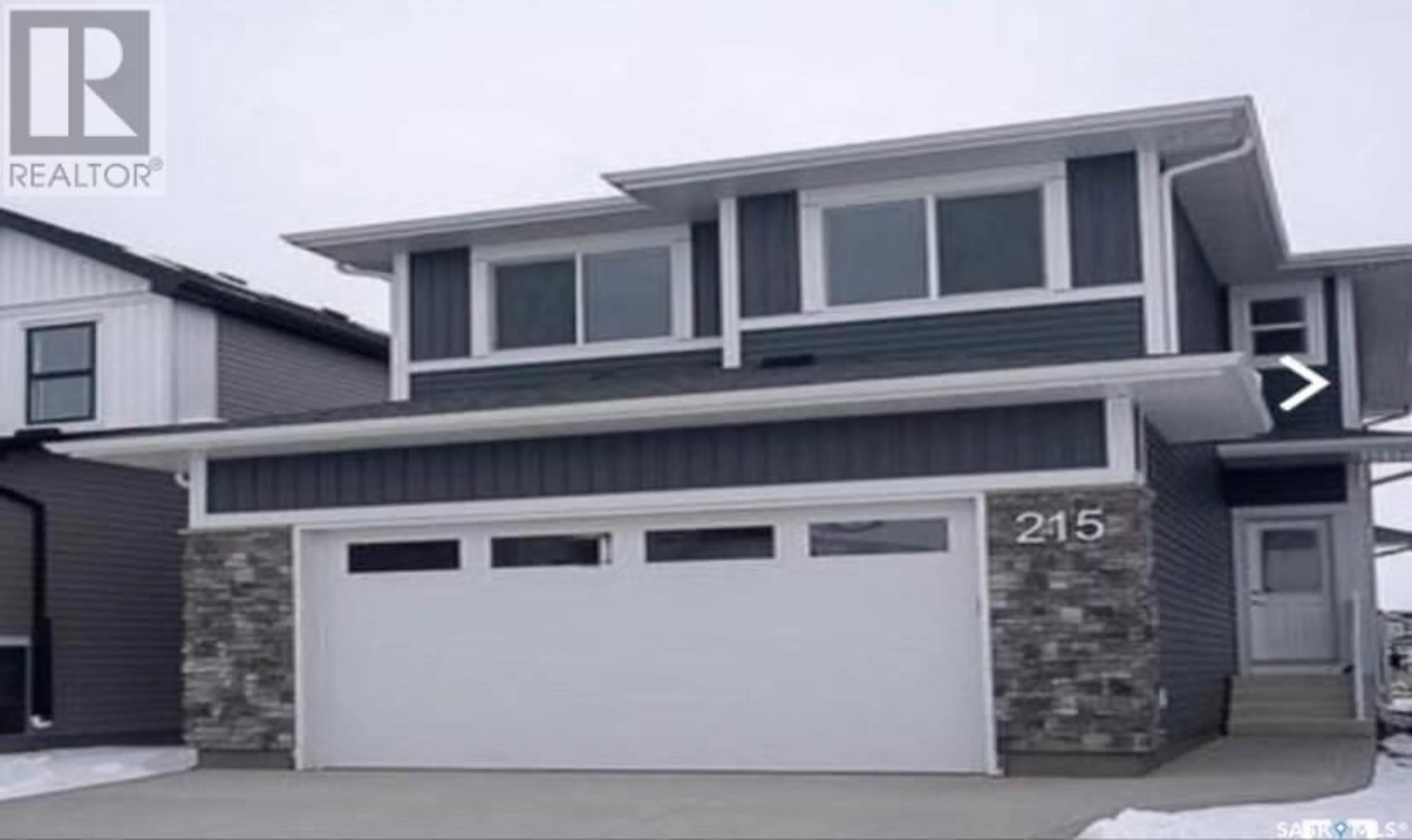 Home with vinyl exterior material, street for 215 SKOPIK CRESCENT, Saskatoon Saskatchewan S7V0V7