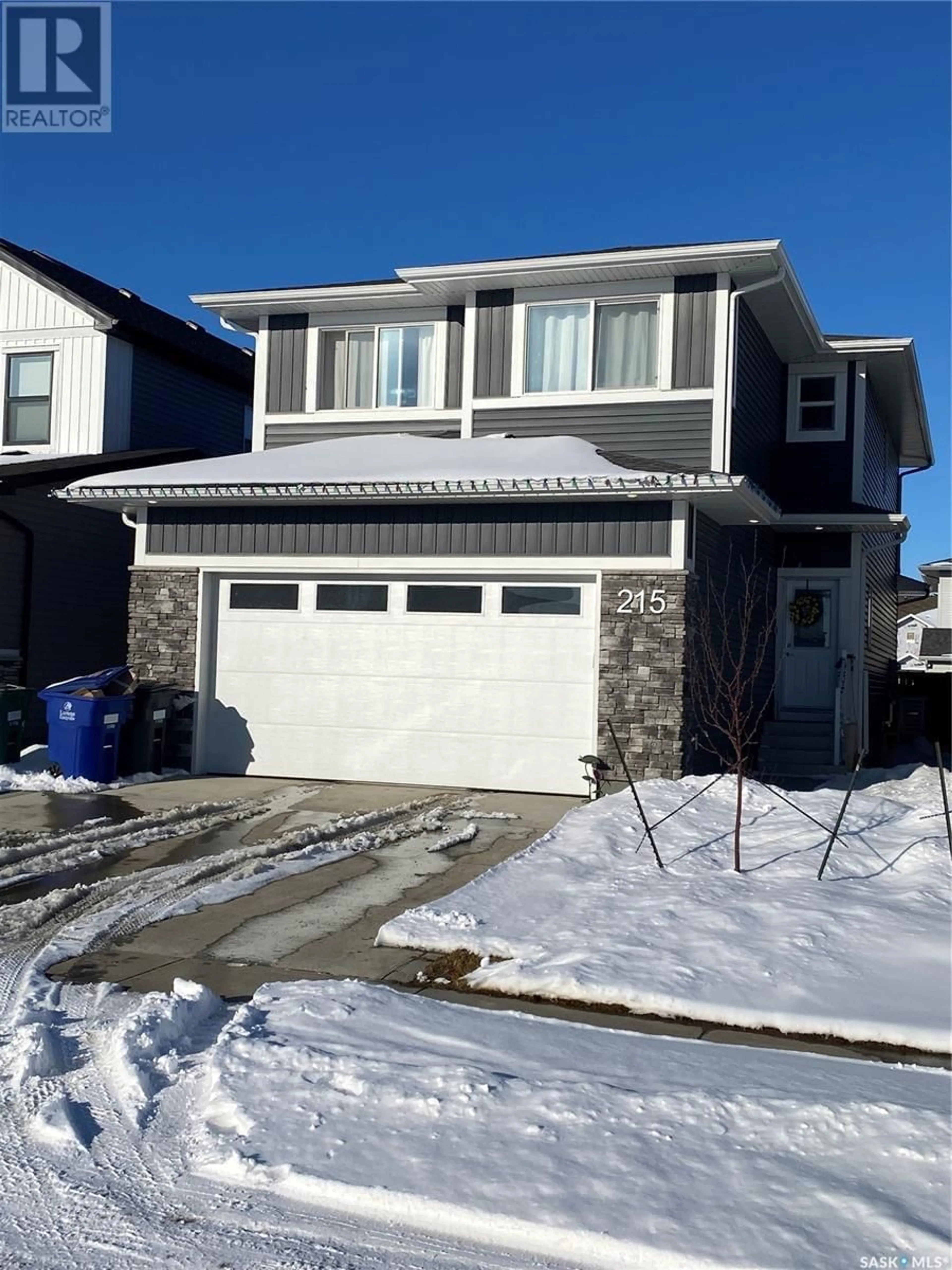 Home with vinyl exterior material, street for 215 SKOPIK CRESCENT, Saskatoon Saskatchewan S7V0V7