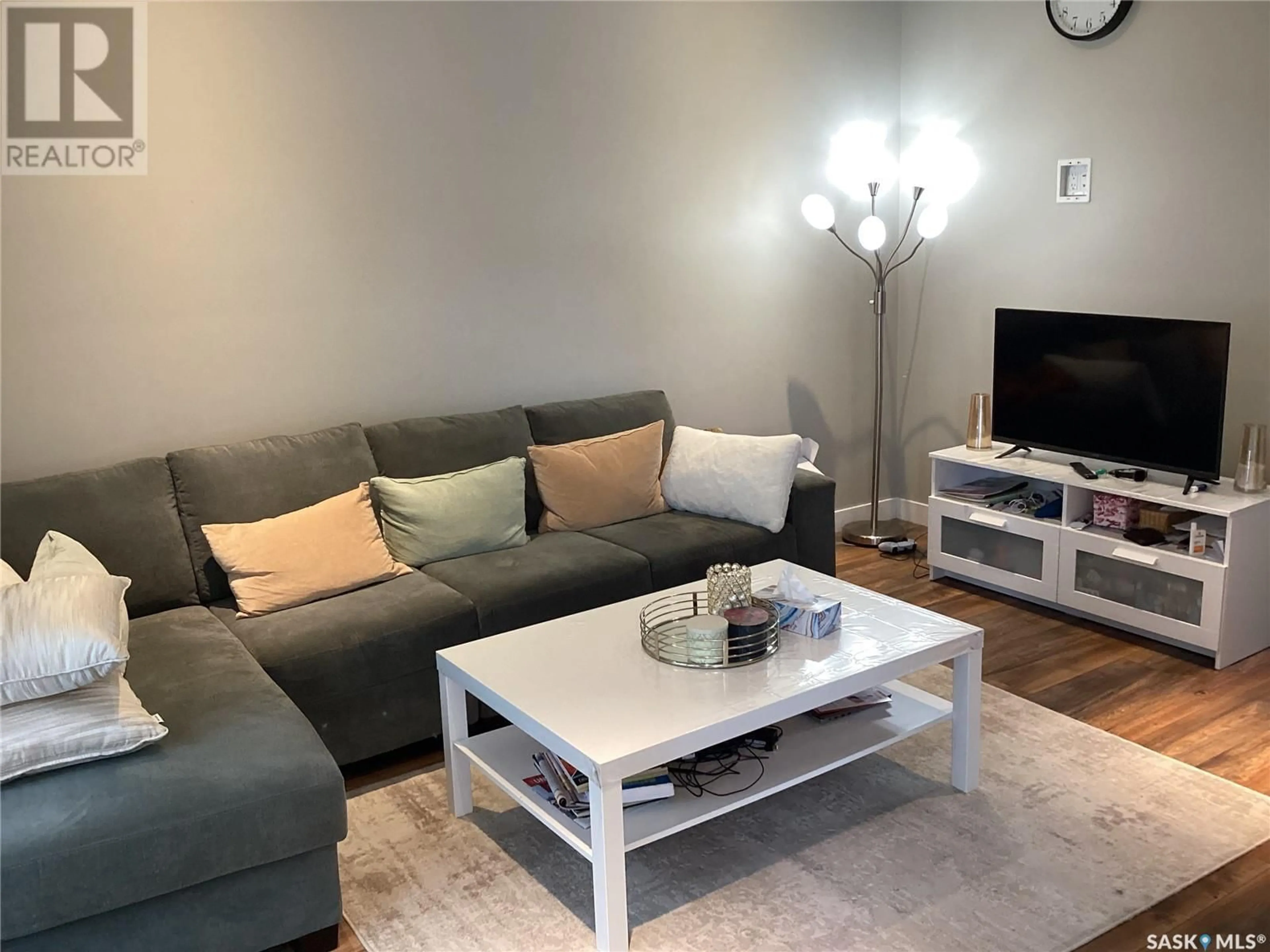 Living room with furniture, wood/laminate floor for 5636 AERODROME ROAD, Regina Saskatchewan S4W0P4