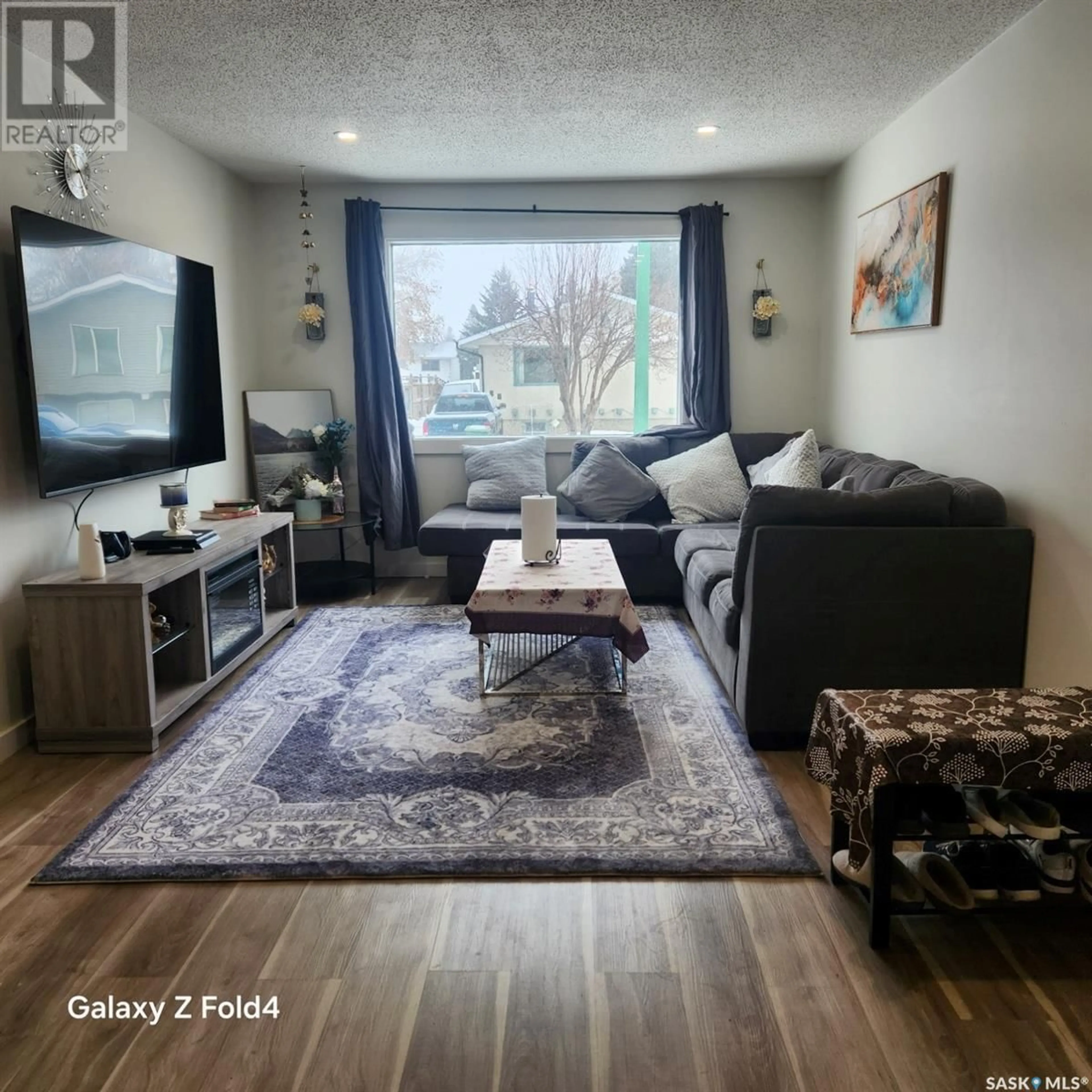 Living room with furniture, wood/laminate floor for 25 PLAXTON PLACE, Prince Albert Saskatchewan S6V6N6
