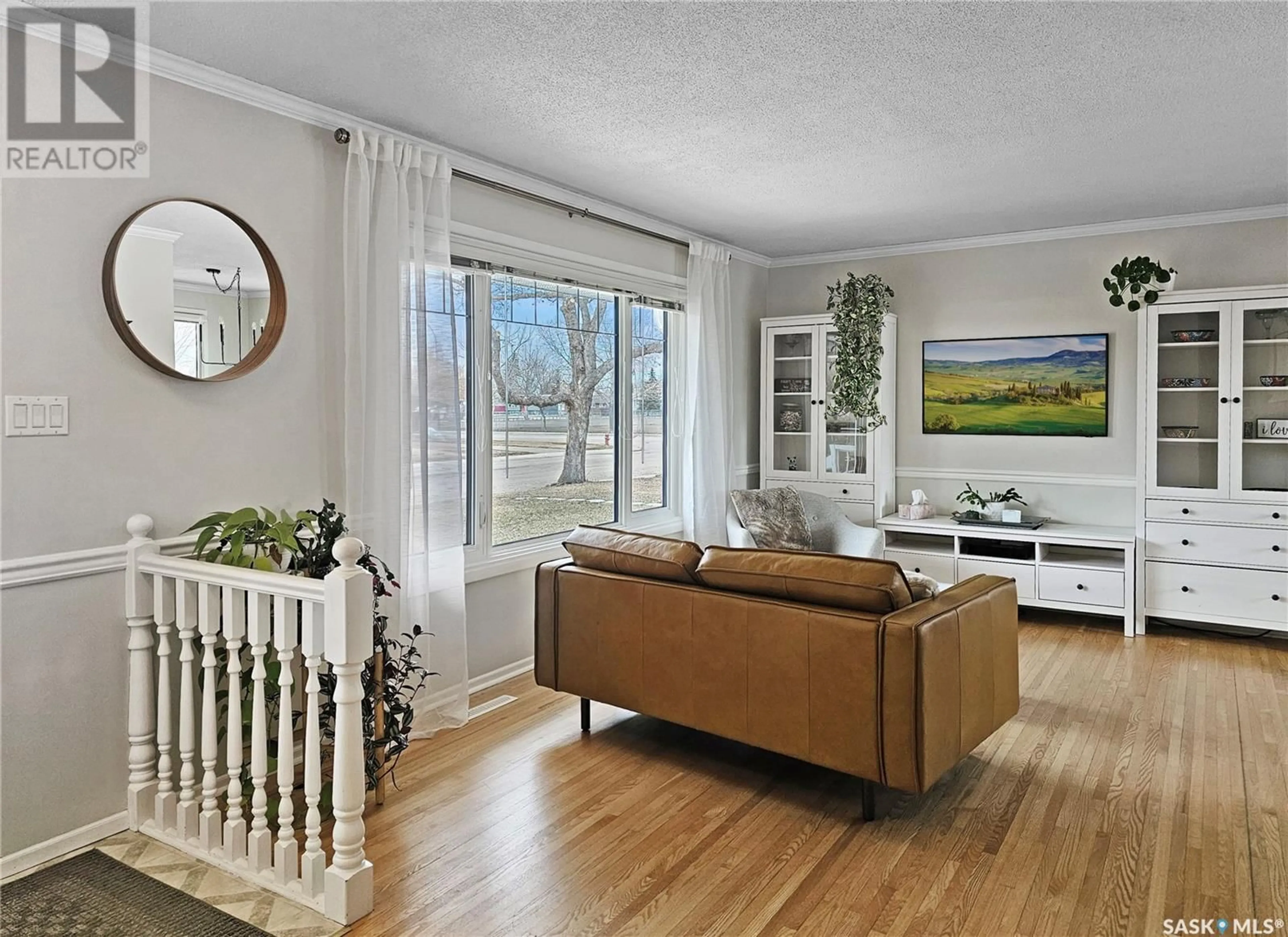 Living room with furniture, wood/laminate floor for 445 LAURIER DRIVE, Swift Current Saskatchewan S9H1L3