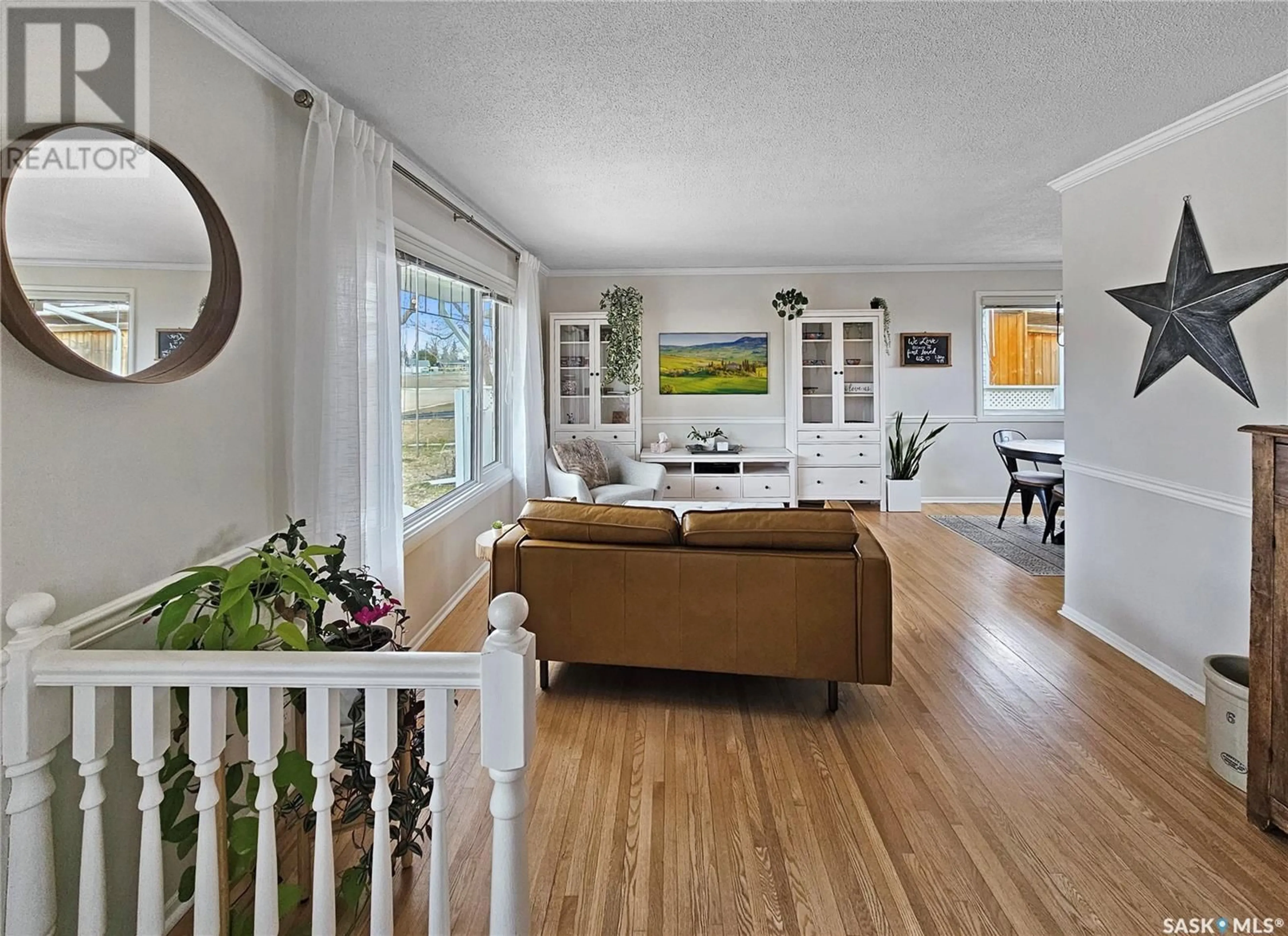 Living room with furniture, wood/laminate floor for 445 LAURIER DRIVE, Swift Current Saskatchewan S9H1L3