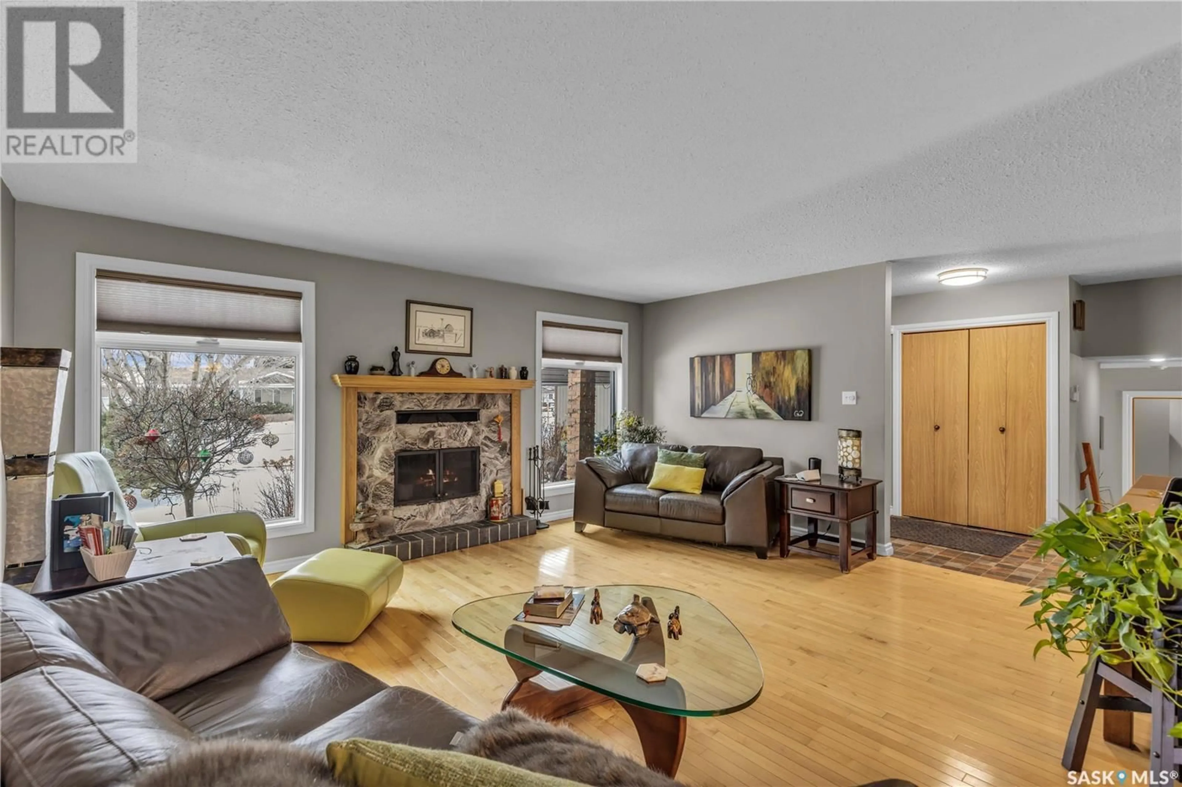 Living room with furniture, wood/laminate floor for 10616 BENNETT CRESCENT, North Battleford Saskatchewan S9A3X3