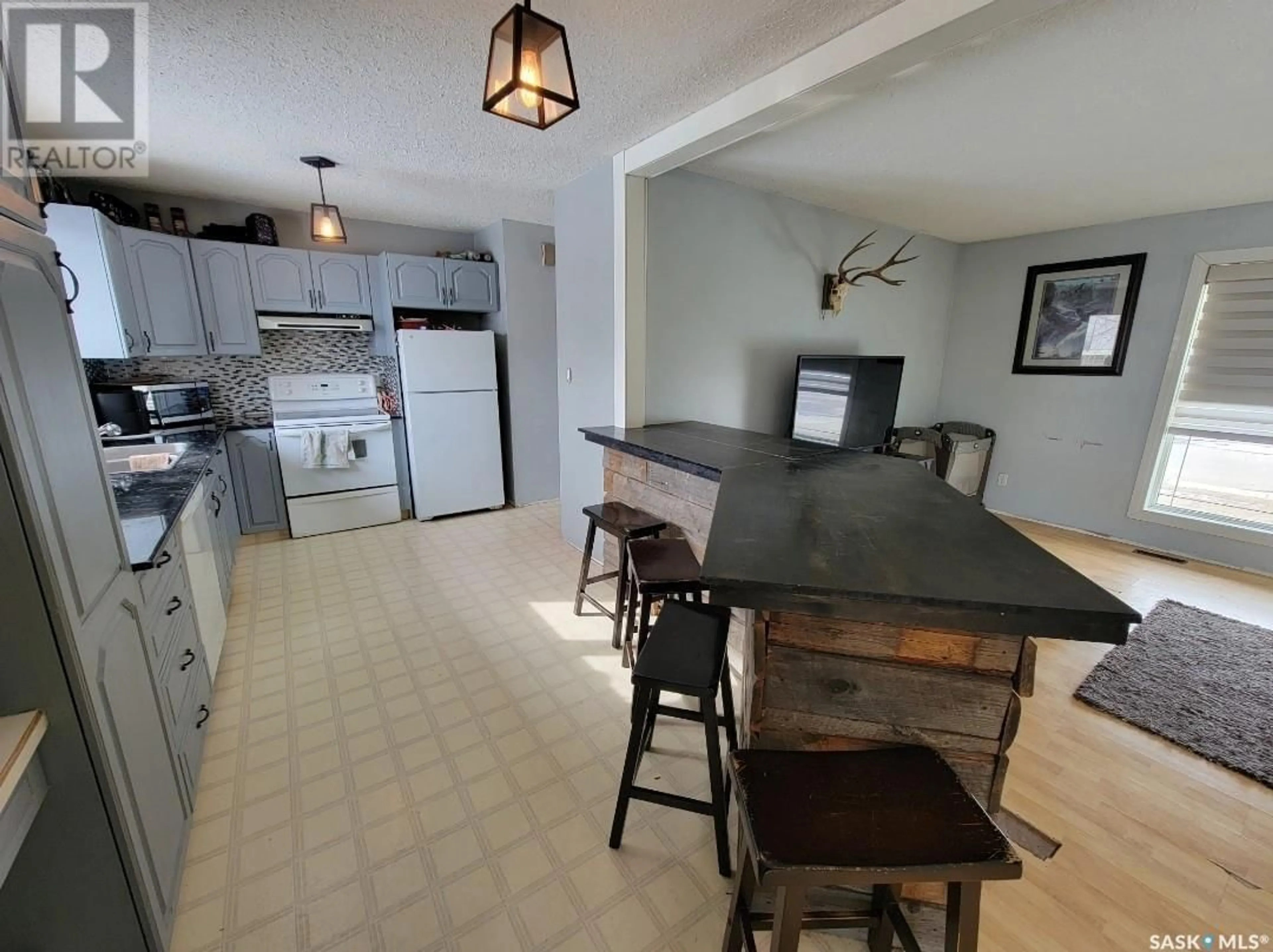Living room with furniture, wood/laminate floor for 5034 MIRROR DRIVE, Macklin Saskatchewan S0L2S0