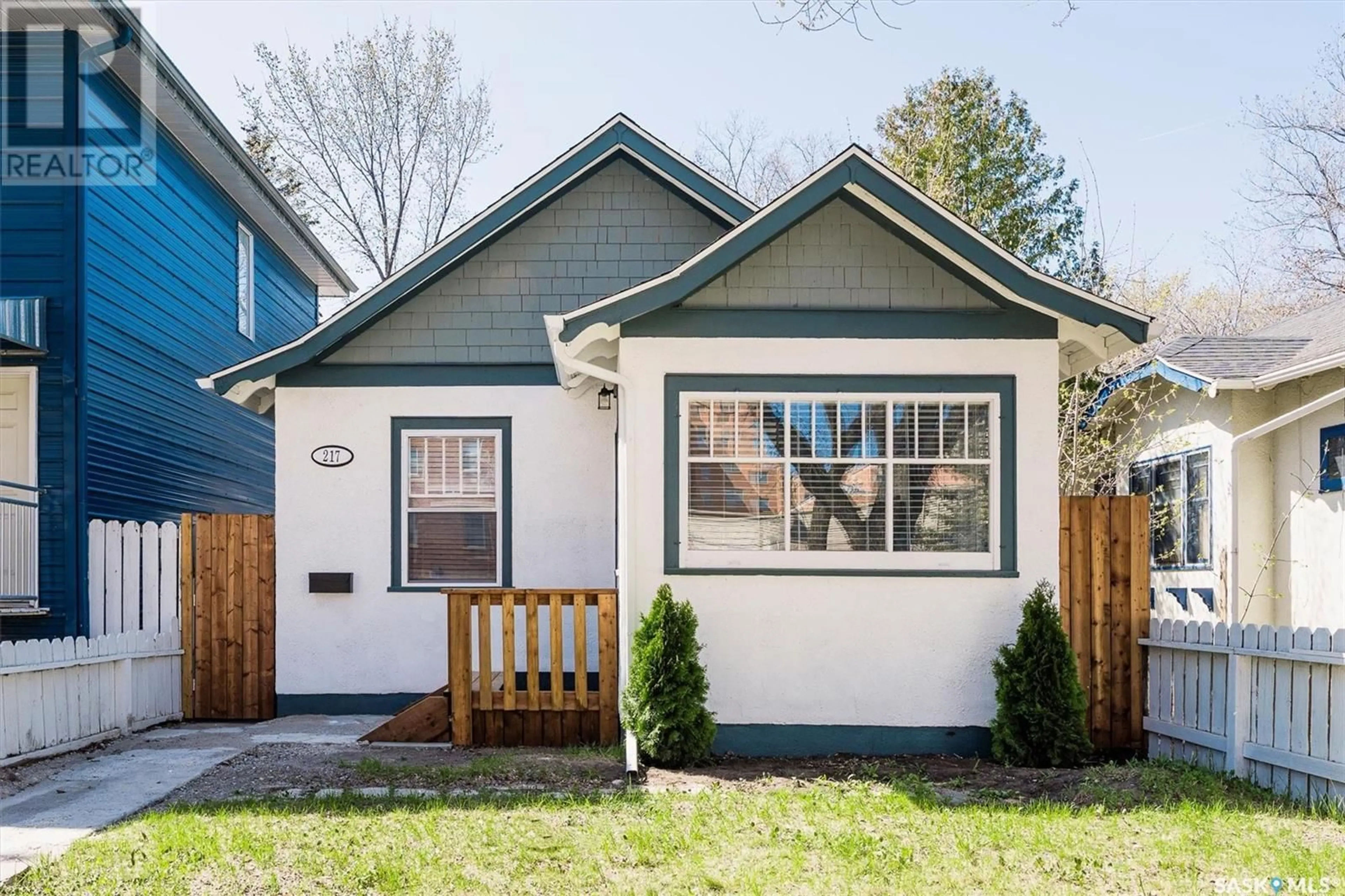 Home with vinyl exterior material, street for 217 R AVENUE S, Saskatoon Saskatchewan S7M2Y9
