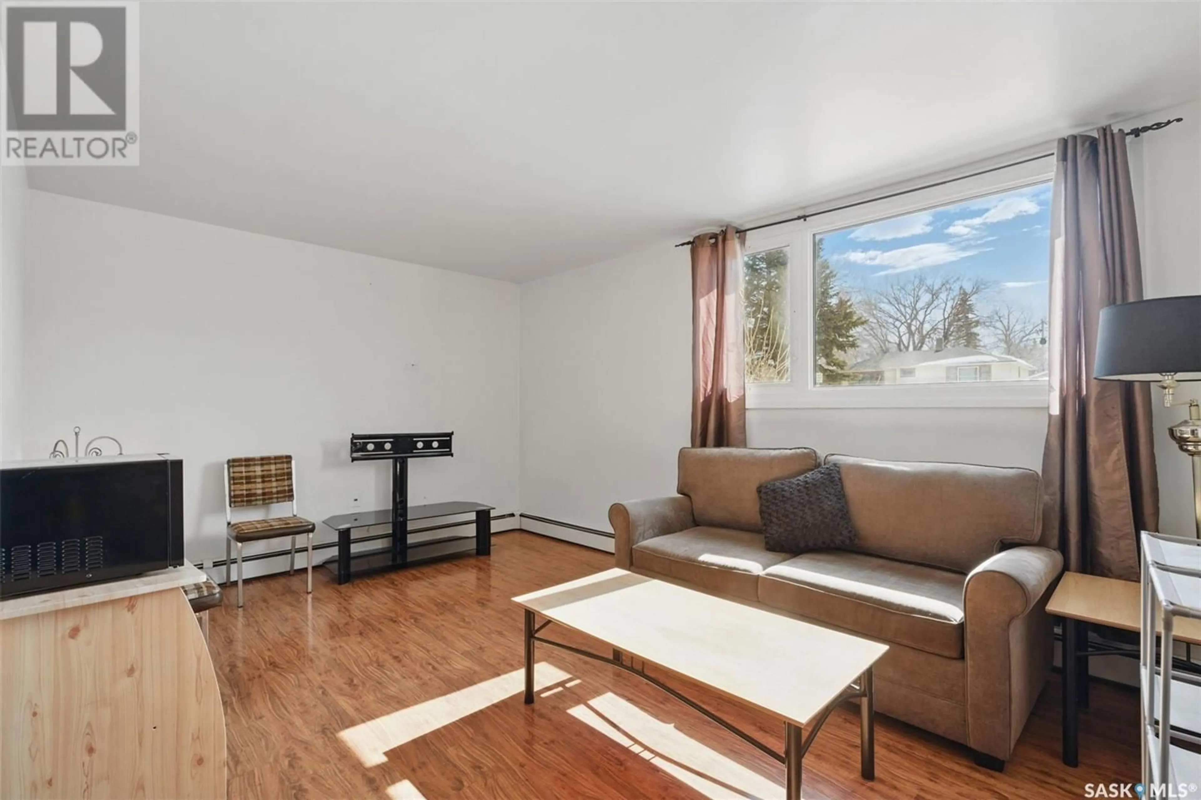 Living room with furniture, wood/laminate floor for 108 3RD AVENUE, Watrous Saskatchewan S0K4T0