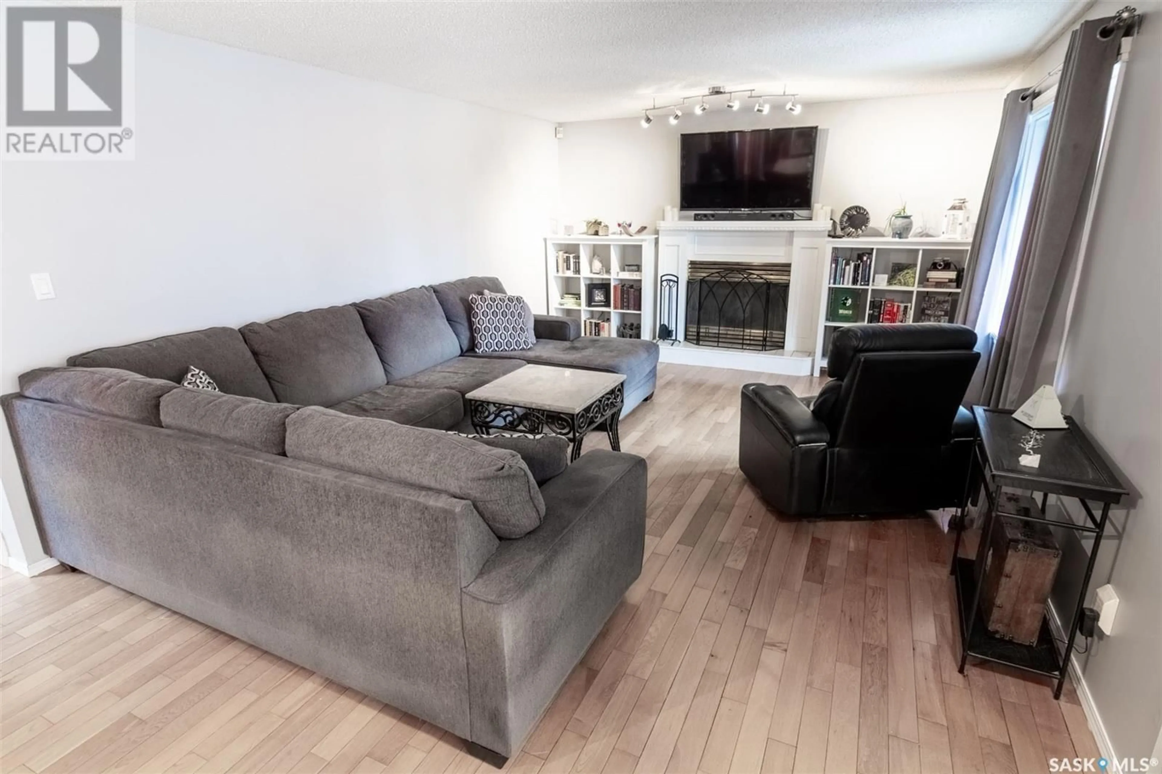 Living room with furniture, wood/laminate floor for 1324 BENJAMIN CRESCENT, Regina Saskatchewan S4X4K1