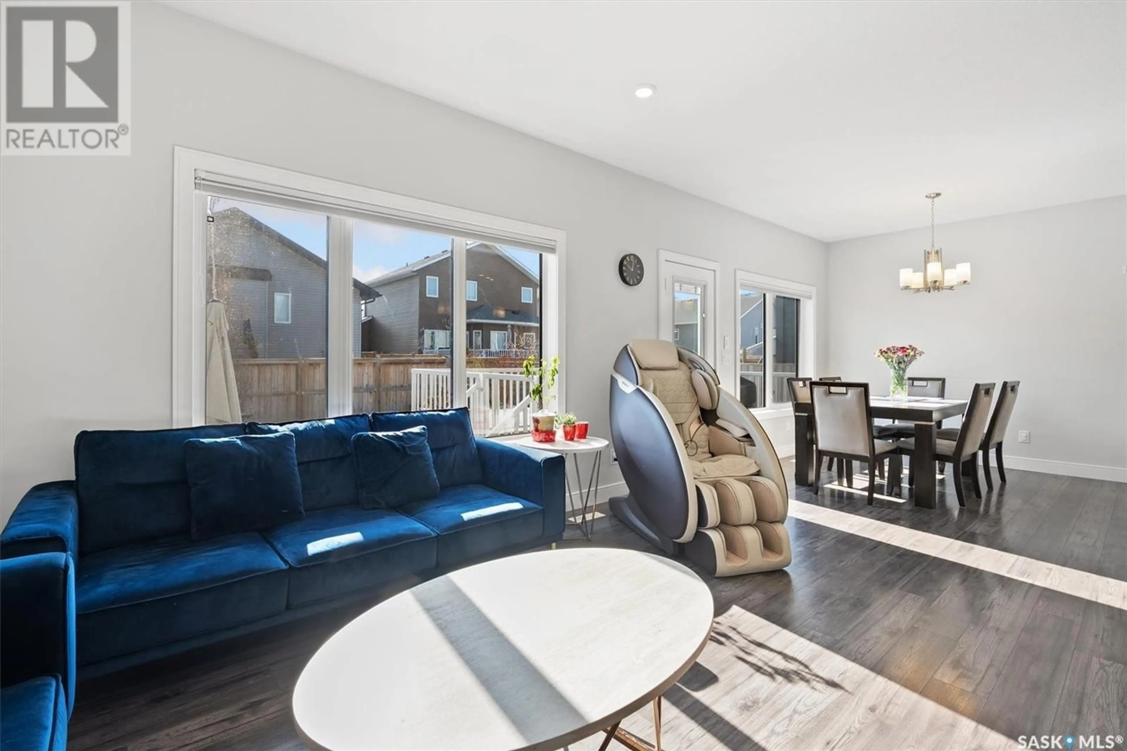 Living room with furniture, wood/laminate floor for 819 PRINGLE COVE, Saskatoon Saskatchewan S7T1C9