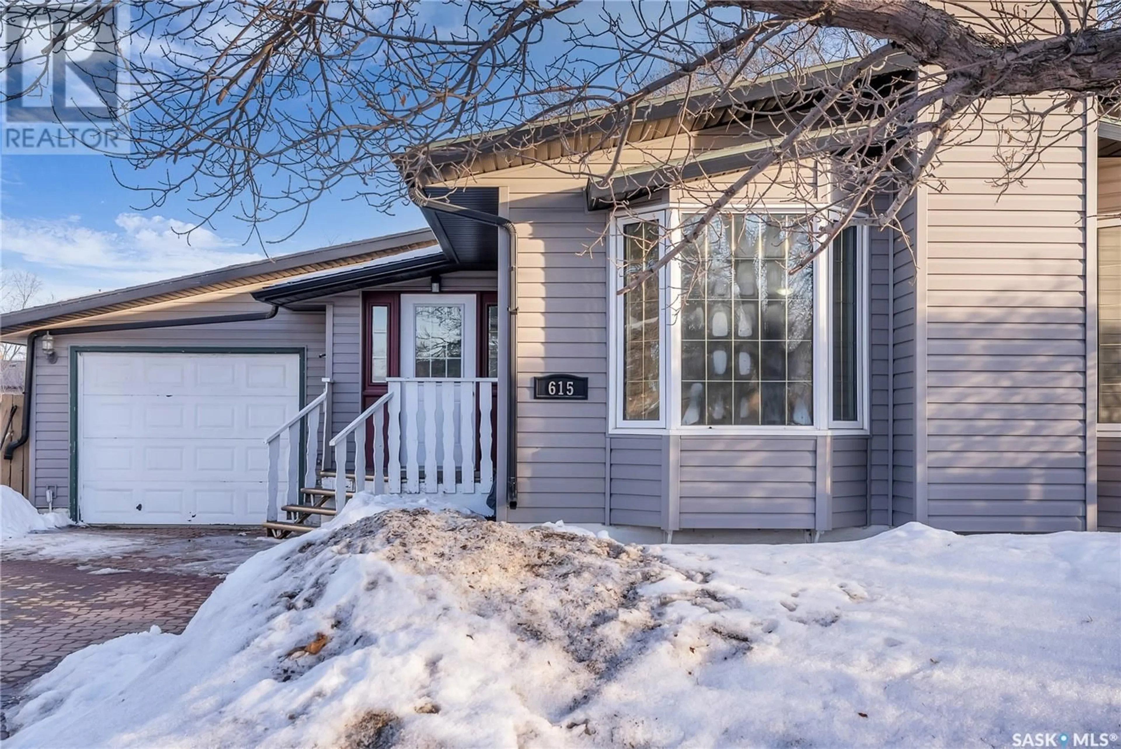 Home with vinyl exterior material, street for 615 LENORE DRIVE, Saskatoon Saskatchewan S7K5G7