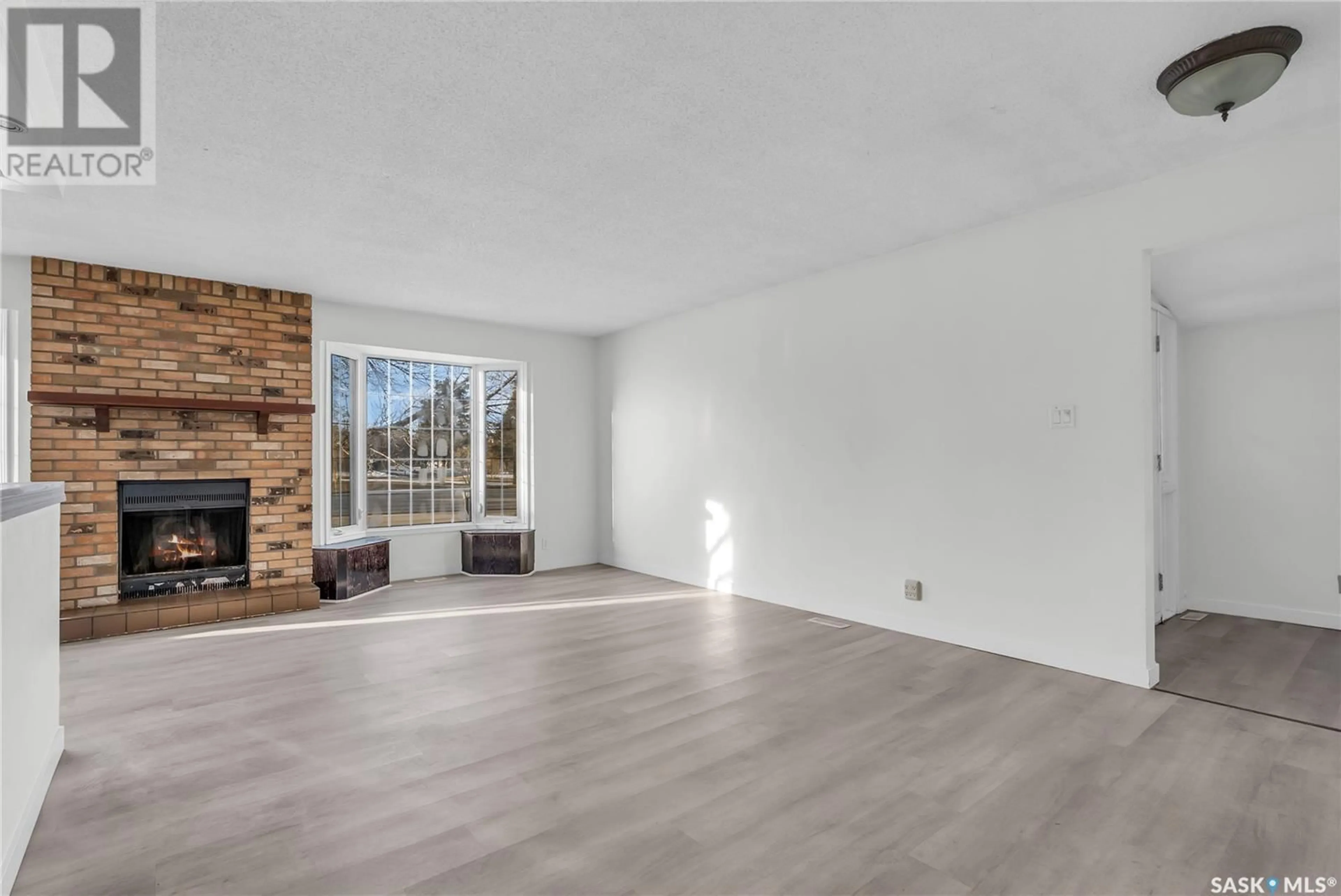 Living room with furniture, wood/laminate floor for 615 LENORE DRIVE, Saskatoon Saskatchewan S7K5G7