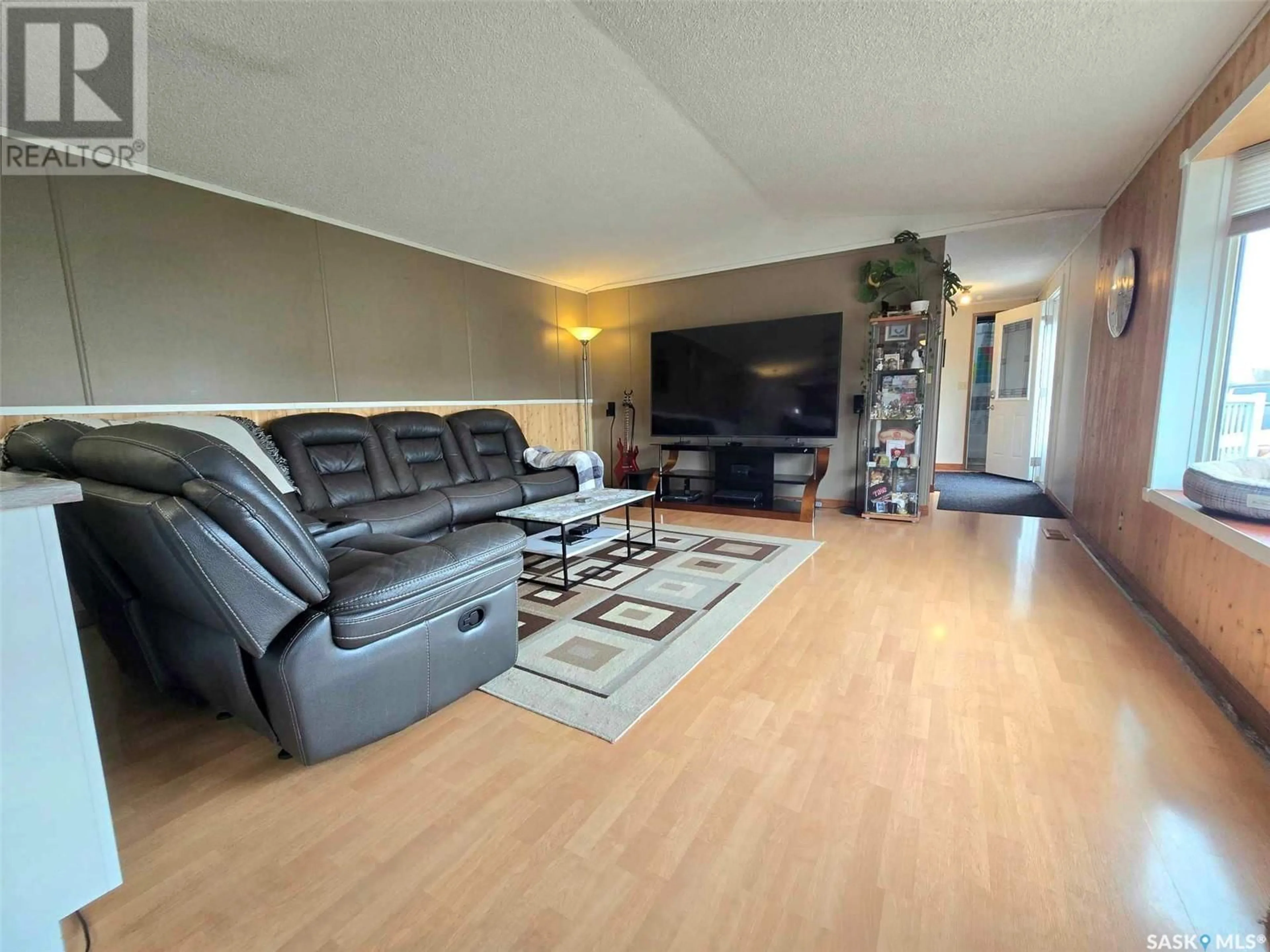 Living room with furniture, wood/laminate floor for 117 MONTREAL STREET, Melville Saskatchewan S0A2P0