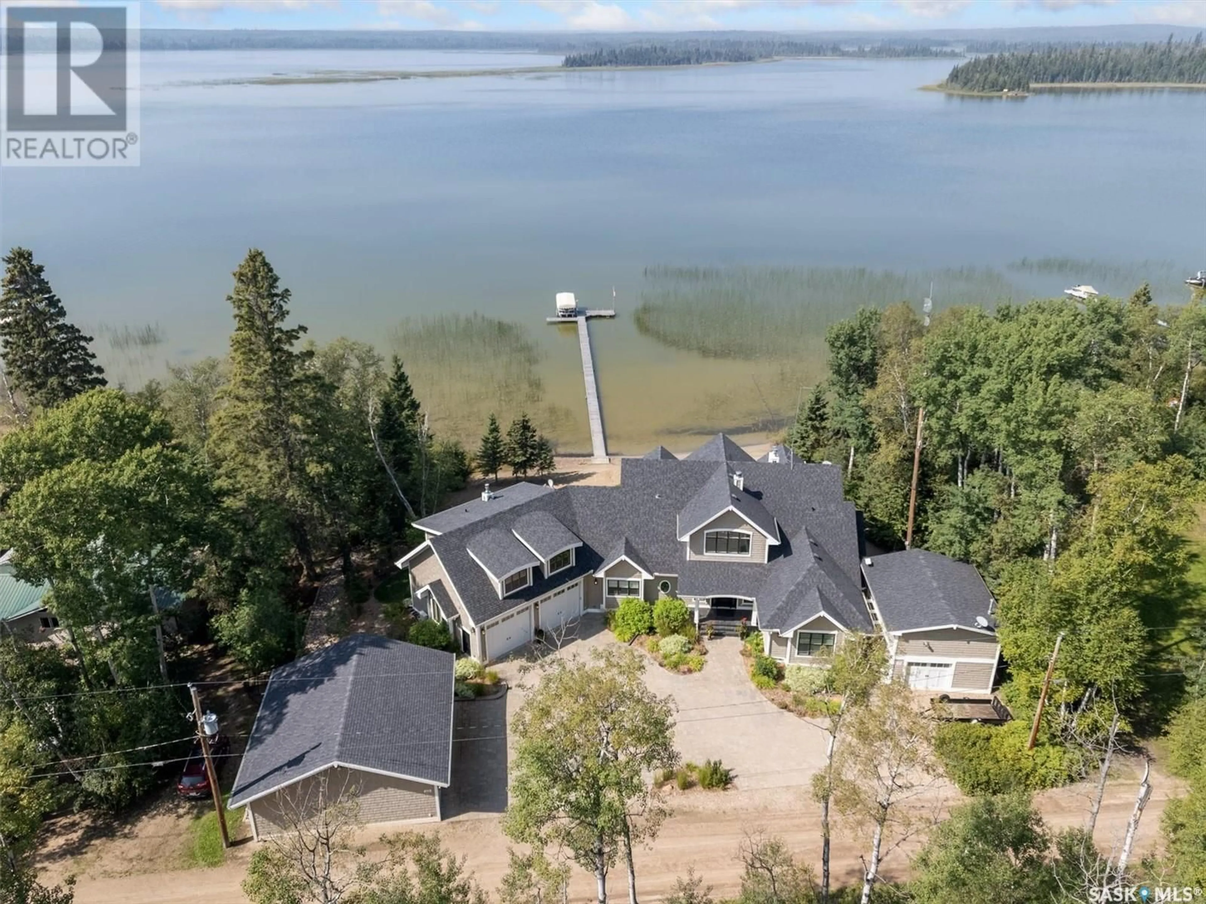 A pic from outside/outdoor area/front of a property/back of a property/a pic from drone, water/lake/river/ocean view for 210 OKEMA TRAIL, Emma Lake Saskatchewan S0J0N0